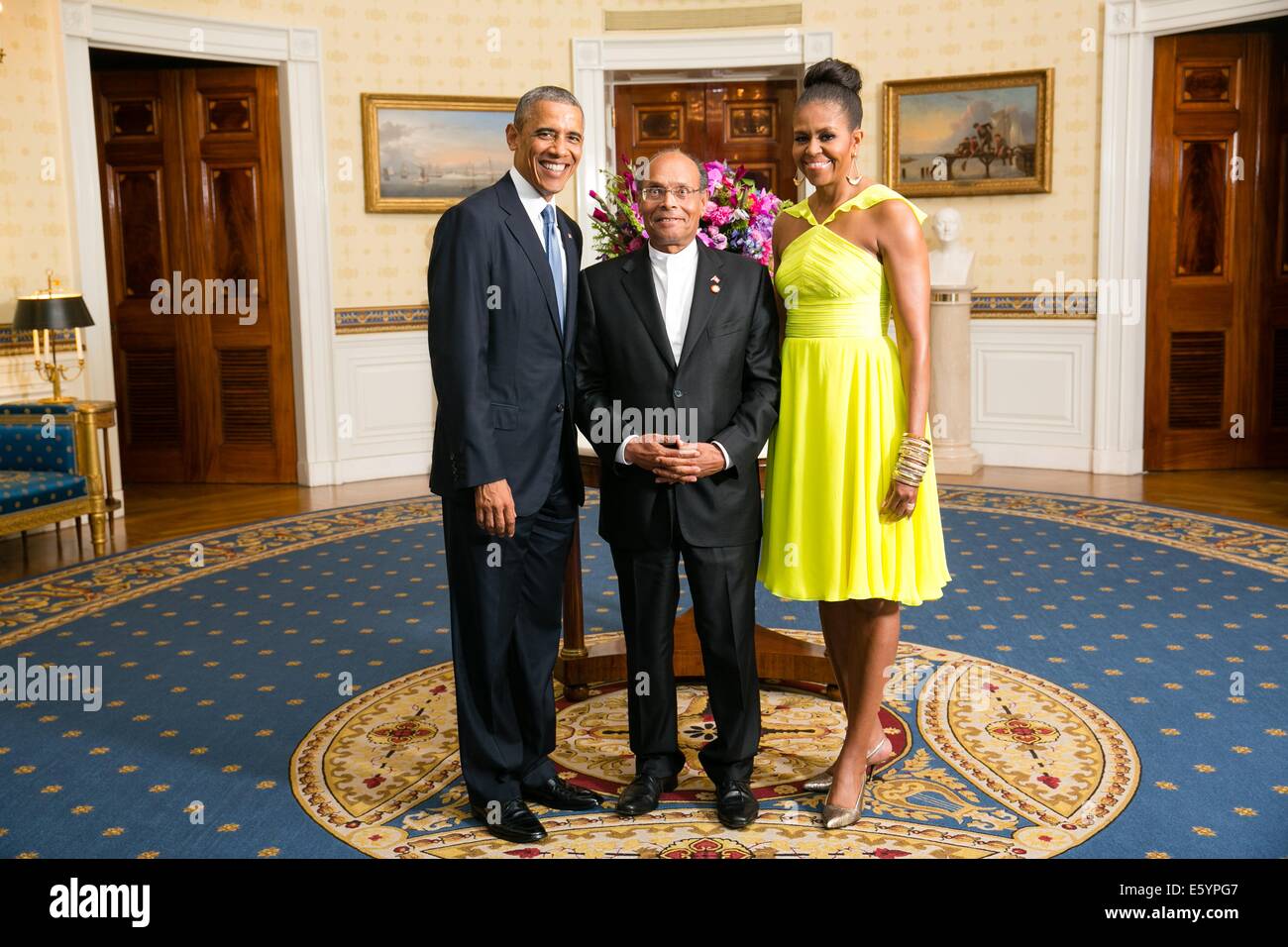 US President Barack Obama and First Lady Michelle Obama pose with Mohamed Moncef Marzouki, President of Tunisia, in the Blue Room of the White House before the U.S.-Africa Leaders Summit dinner August 5, 2014 in Washington, DC. Stock Photo