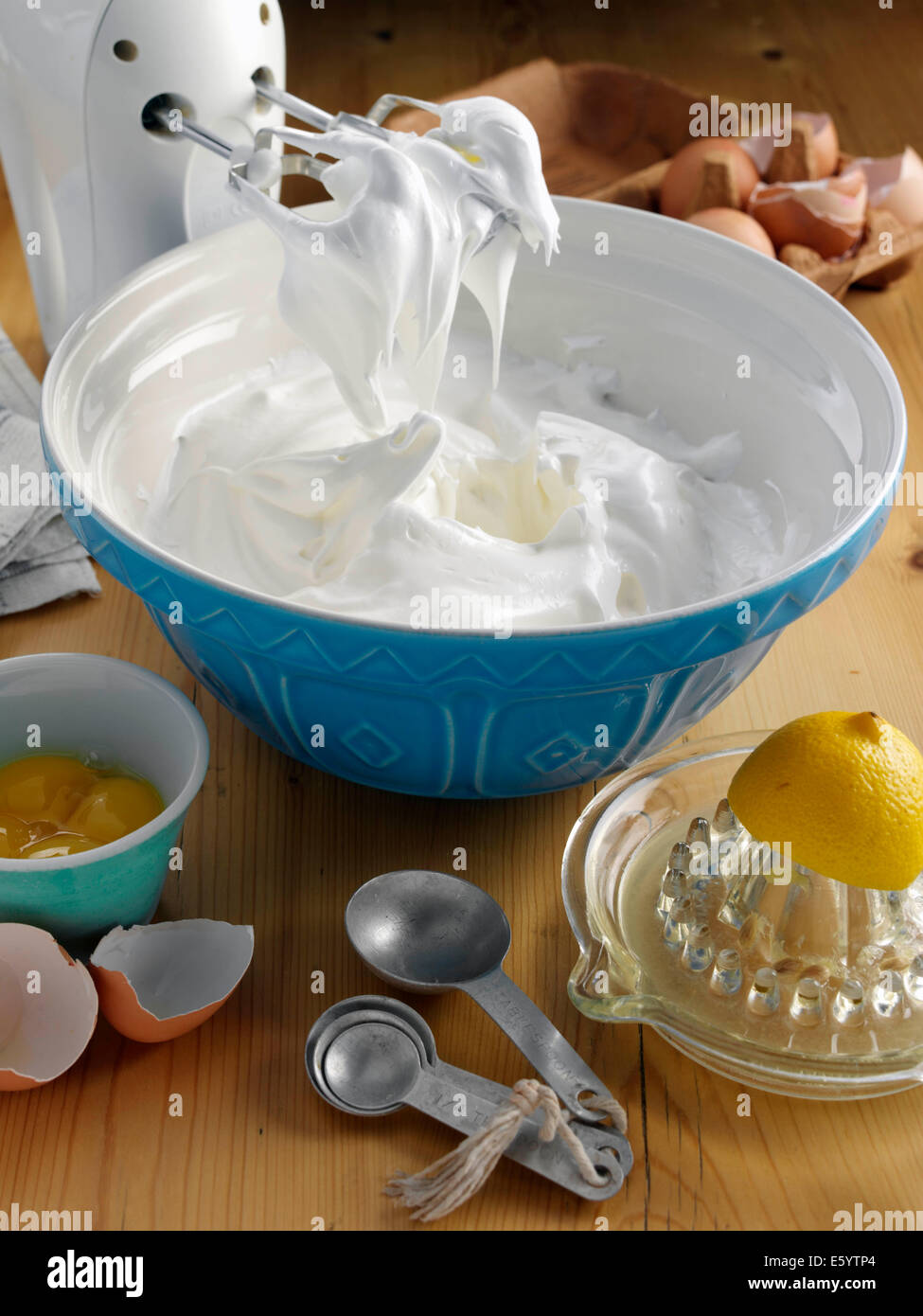 Beating a white cream with a mixer in a metal bowl. Whipped cream. Cream  for the cake Stock Photo - Alamy