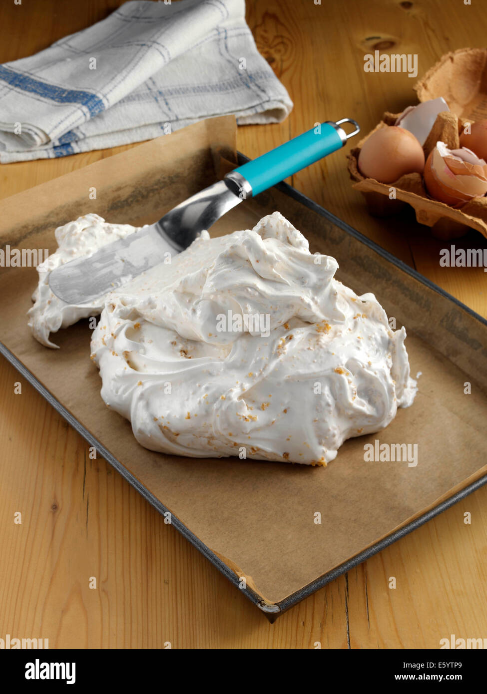 Spreading meringue mixture on baking paper Stock Photo Alamy
