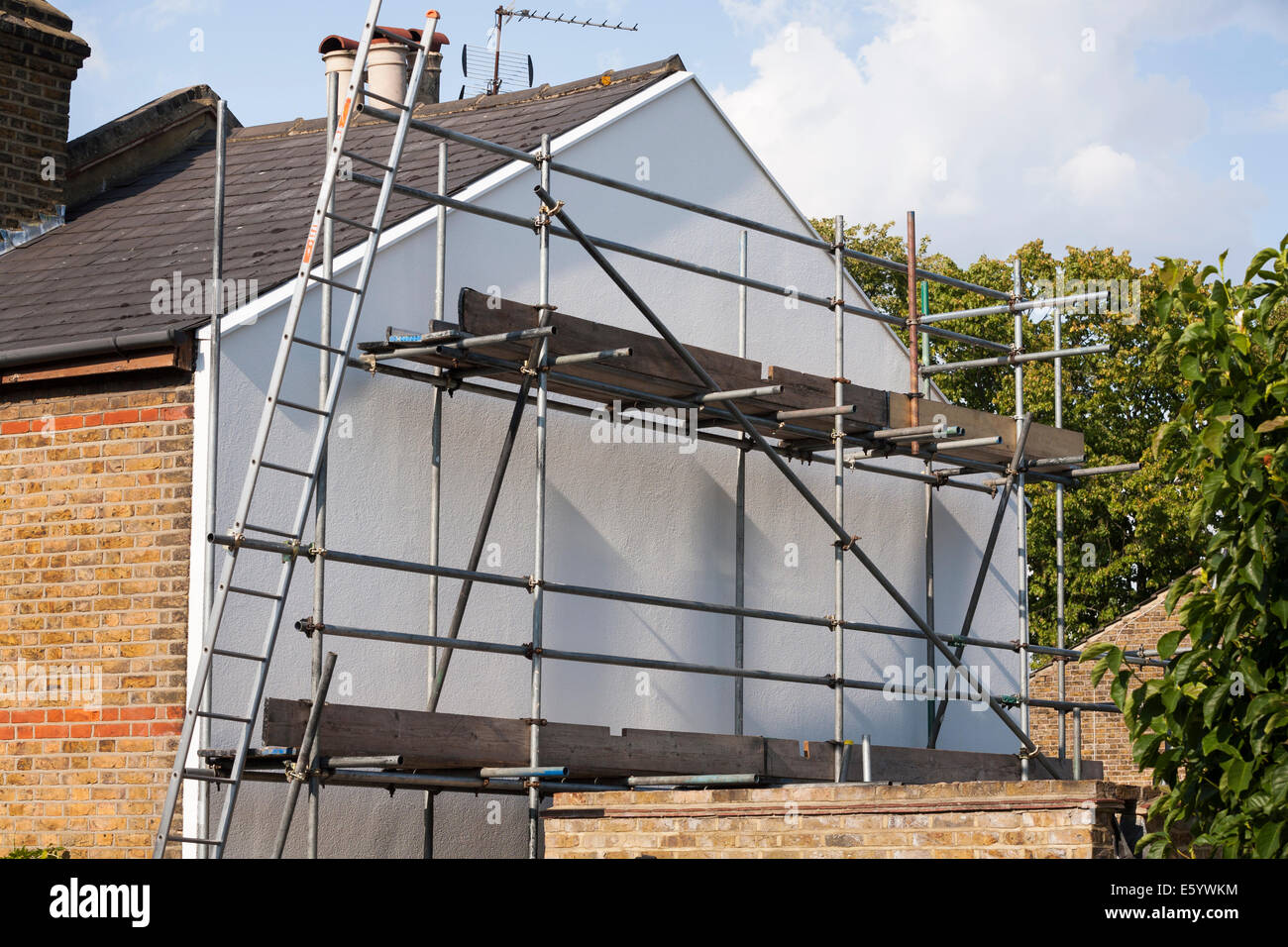 Rigid foam wall insulation and scaffolding on a Victorian terraced house gable end UK Stock Photo