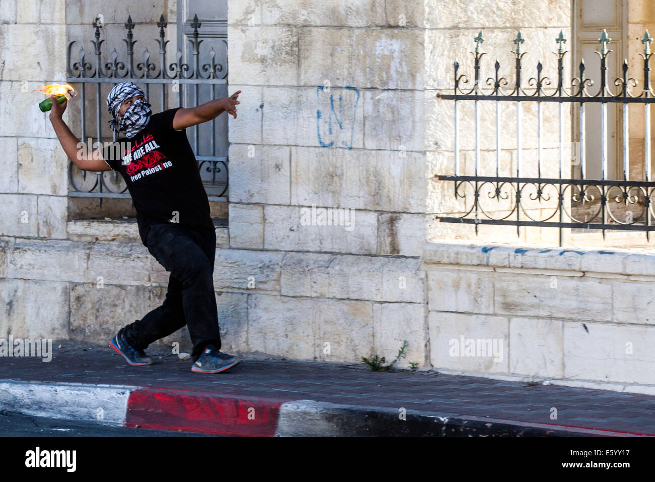 Palestinian youths throw at Rachel's grave in Bethlehem stones and Molotov cocktails at soldiers of the Israel Defense Forces (IDF). The Israeli security forces use tear gas and rubber bullets to drive the protesters. Bethlehem, 08.08.2014 Stock Photo