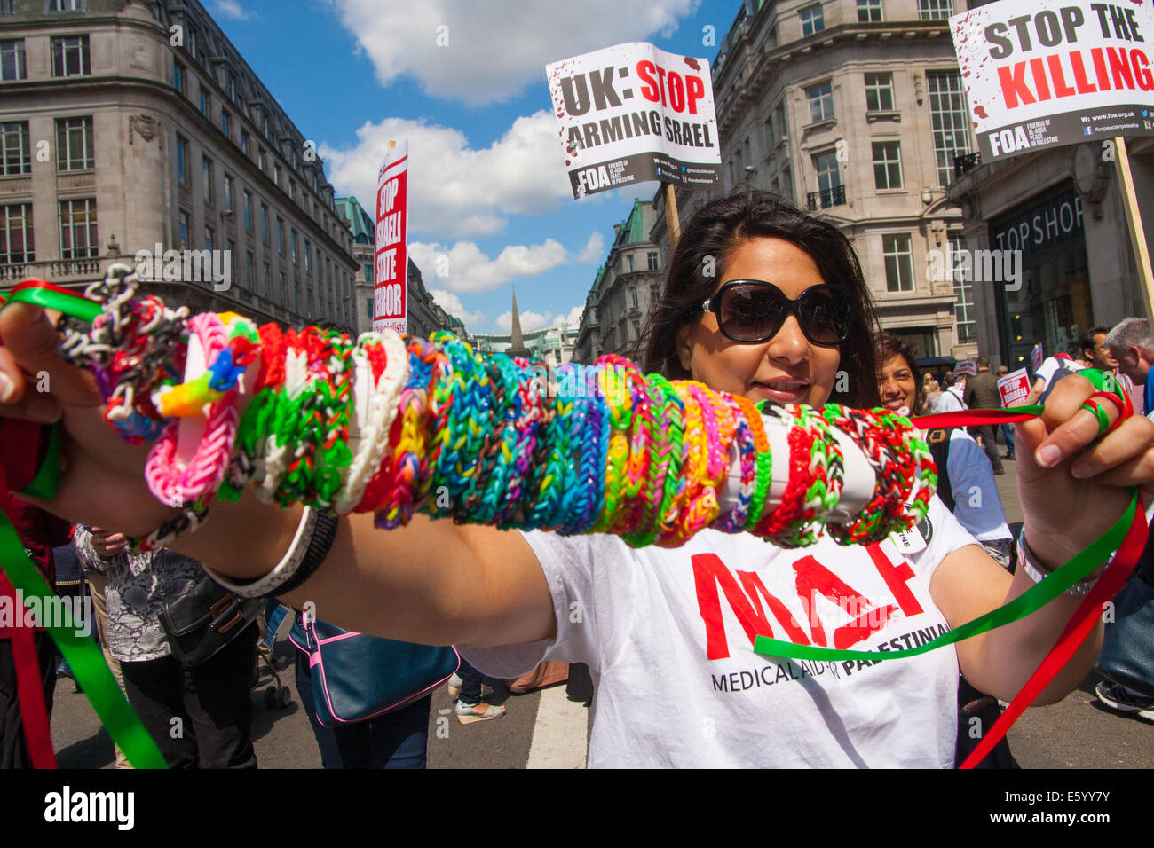 London, UK. 9th August, 2014.  A woman displays her loom bands as tens of thousands from across the UK march in support of the people of |Palestine. Credit:  Paul Davey/Alamy Live News Stock Photo