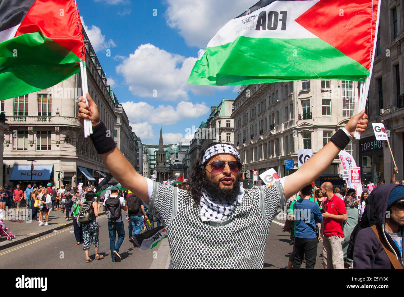 London, UK. 9th August, 2014.  A Protester, one of up to 150,000, awaits the beginning of the march from outside the BBC headquarters in Portland Place, to Hyde Park via the US embassy. Credit:  Paul Davey/Alamy Live News Stock Photo