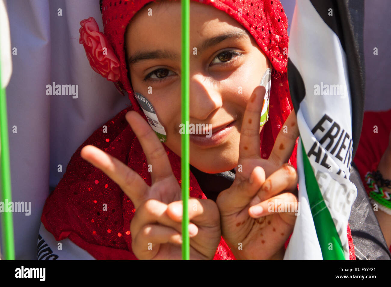 London, UK. 9th August, 2014.  A girl gives a double 'V' for Victory sign after marching with tens of thousands of other Palestinians and their supporters, from the BBC headquarters to a Rally in Hyde Park. Credit:  Paul Davey/Alamy Live News Stock Photo