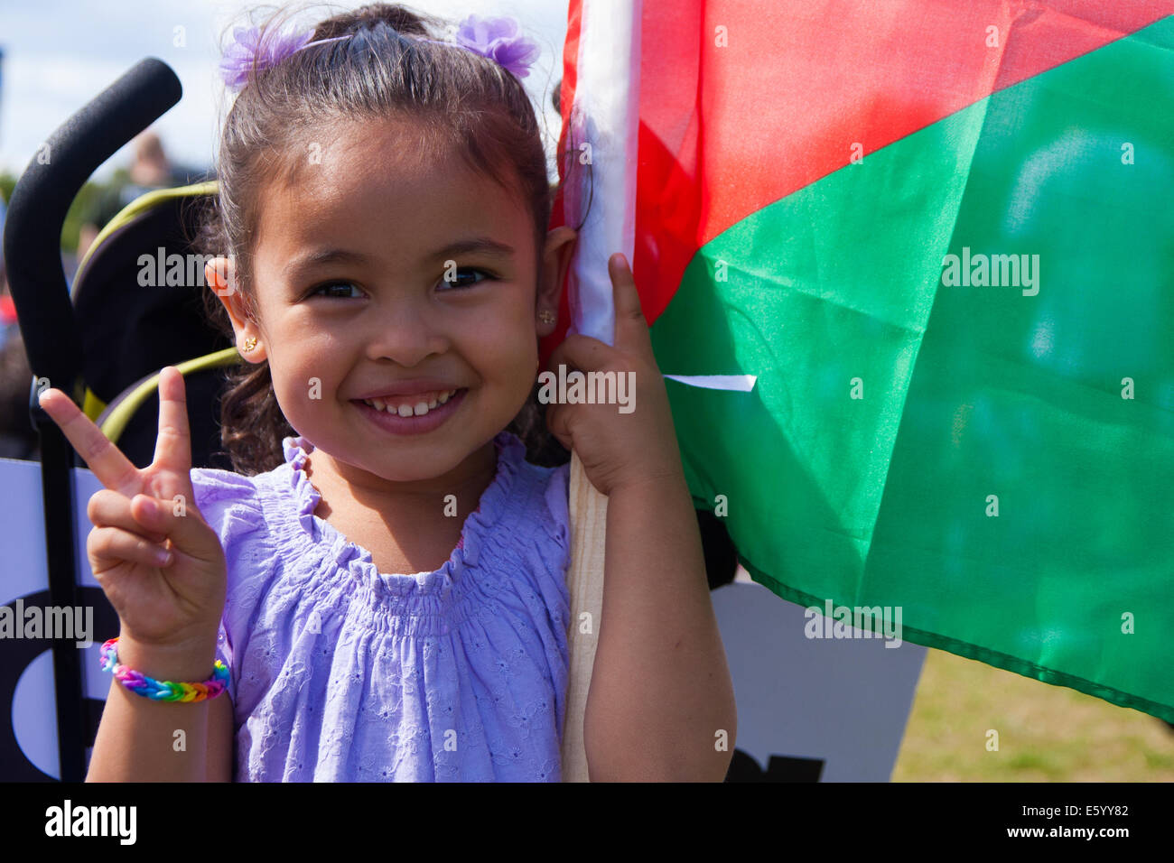 London, UK. 9th August, 2014.  A little girl gives a 'V' for victory sign as she and her parents along with up to 150,000 others, attend the post-march rally in Hyde Park. Credit:  Paul Davey/Alamy Live News Stock Photo