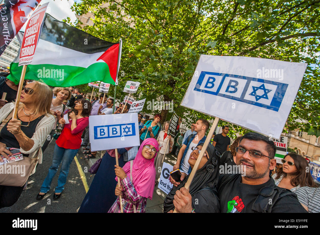 London, UK. 9th august, 2014. Outside the BBC a huge flag is unfurled and as the march heads off peace signs alternate with pointing and chanting - Shame on you. Stop the 'massacre' in Gaza protest. A demonstration called by the Palestine Solidarity Campaign (PSC). They assembled at the BBC offices in Regent Street and marched to The US Embassy and on to a rally in Hyde Park. They called for 'Israel's bombing and killing to stop now and for David Cameron to stop supporting Israeli war crimes'. London, 09 Aug 2014. Credit:  Guy Bell/Alamy Live News Stock Photo