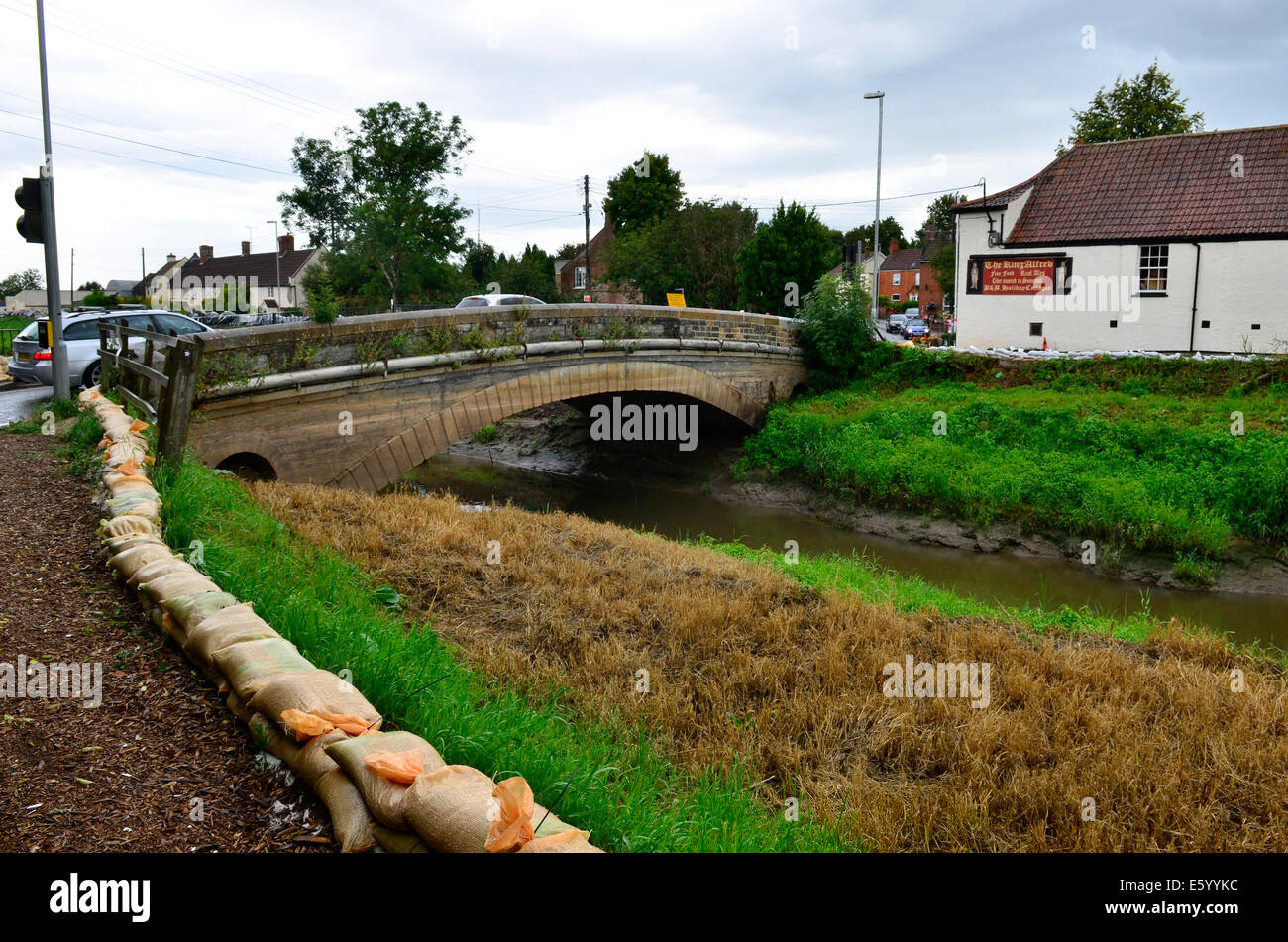 Burrowbridge, Somerset, UK. 9th August, 2014. UK weather:  An Emergency call out for local helpers to make more Sandbags to be put in place around the bridge and along the Main Road opposite due to very bad weather forecast moving in. Credit:  Robert Timoney/Alamy Live News Stock Photo