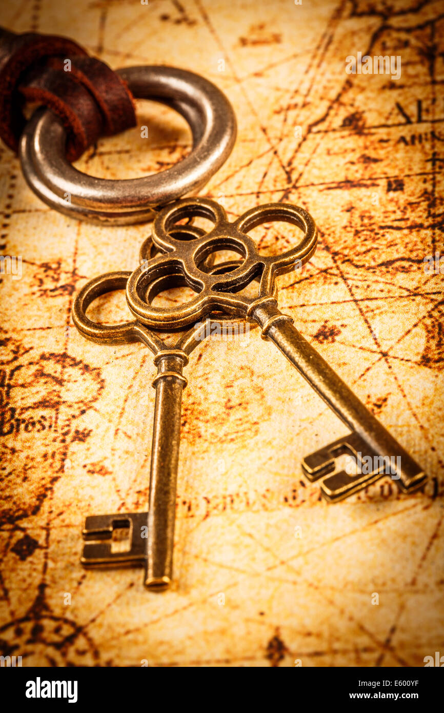 Old keys on an ancient world map Stock Photo