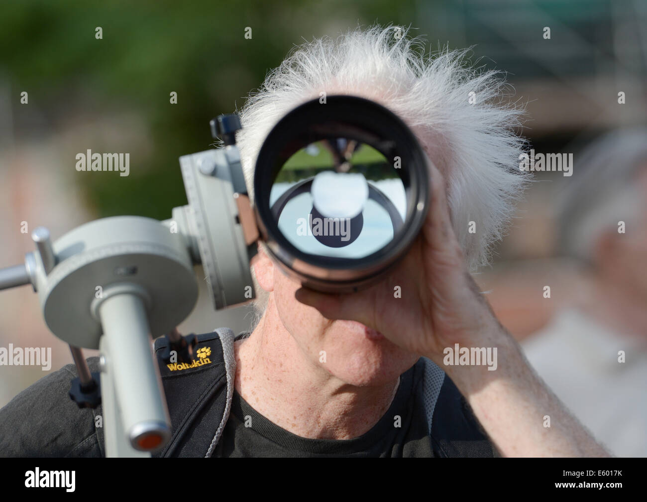 Berlin, Germany. 09th Aug, 2014. A man looks through a telescope during