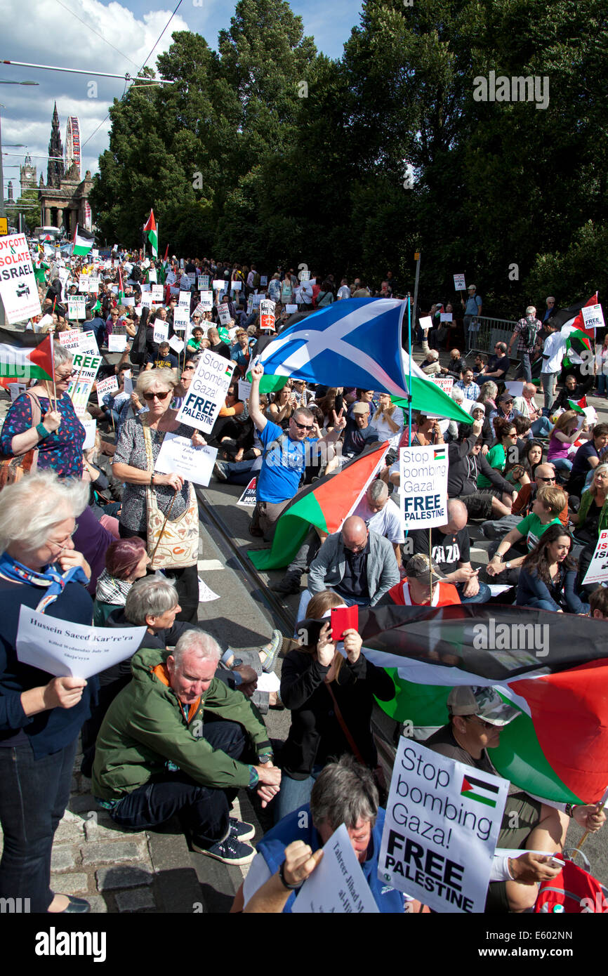 Edinburgh, Scotland, UK. 9th August, 2014. Scottish supporters of Palestinian rights took part in a rally at the Mound and march along Princes Street  in Edinburgh as part of a a day of protest by the Boycott, Divestment and Sanctions (BDS) movement to highlight the situation in Gaza and in Palestine. They also had a sit down in Princes Street for two minutes silence to remember the dead. Stock Photo