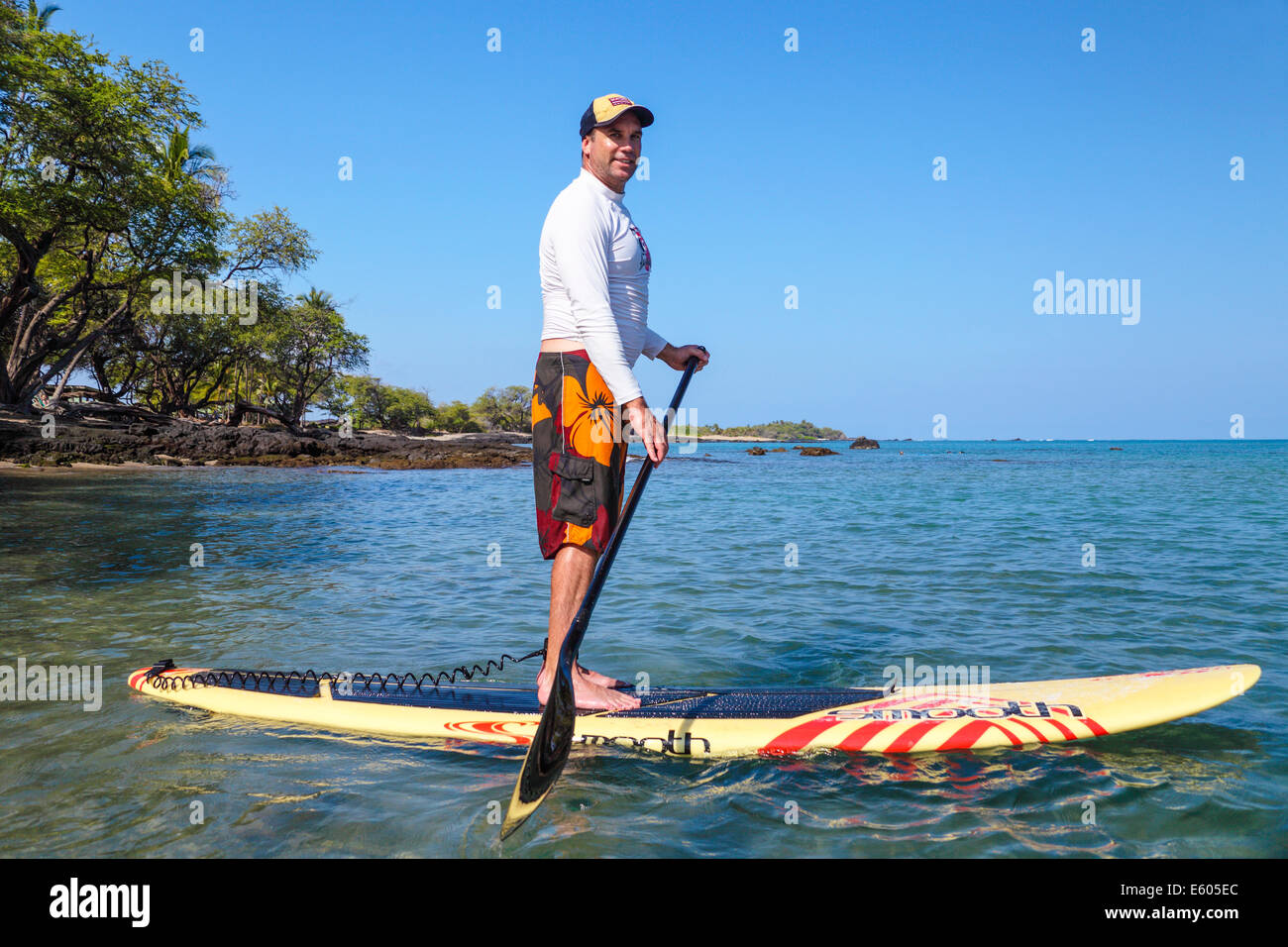 Stand up paddle boarder in Anaehoomalu Bay in Waikoloa on the Big Island of Hawaii Stock Photo