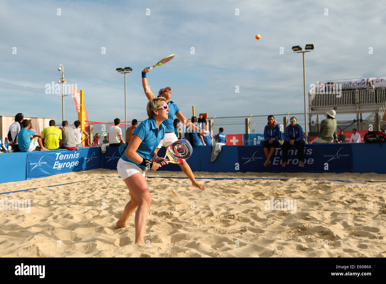 City of Brighton & Hove, East Sussex, UK. European Beach Tennis Championships 2014 Brighton, Yellow Wave, Madeira Drive, Brighton, Sussex, UK. In this image is a women's doubles quarter final between teams from France in shot and Germany. 9th August 2014 David Smith/Alamy Live News Stock Photo