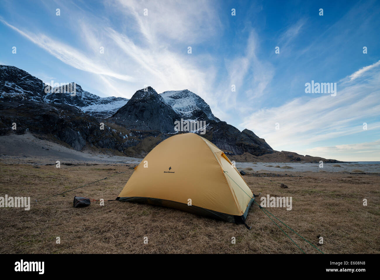 Tent pitched below mountains at Bunes beach, Moskenesøy, Lofoten Islands, Norway Stock Photo