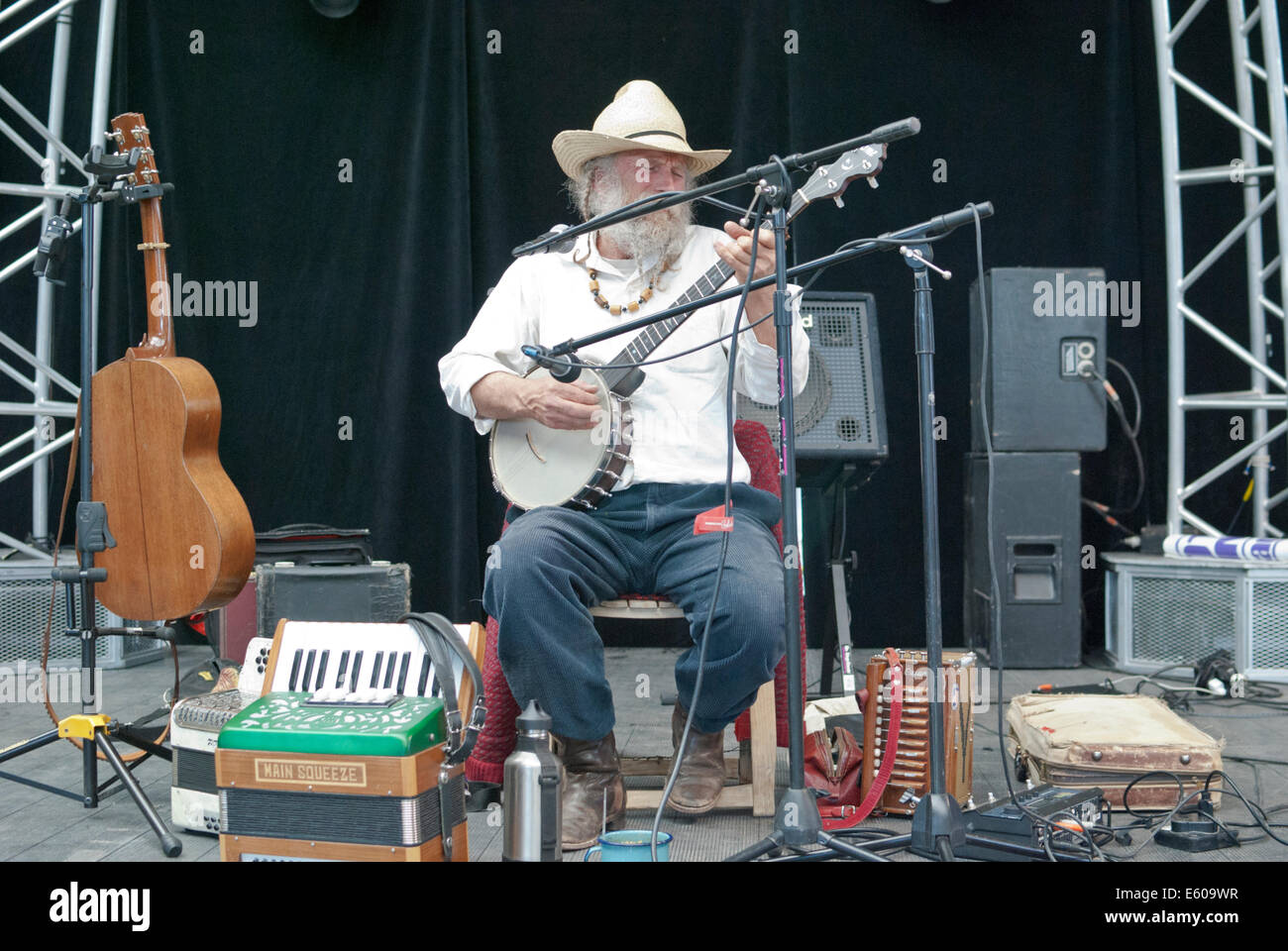 A local musician plays the banjo,accordions, and other instruments at the farmers market in Santa Fe. Stock Photo