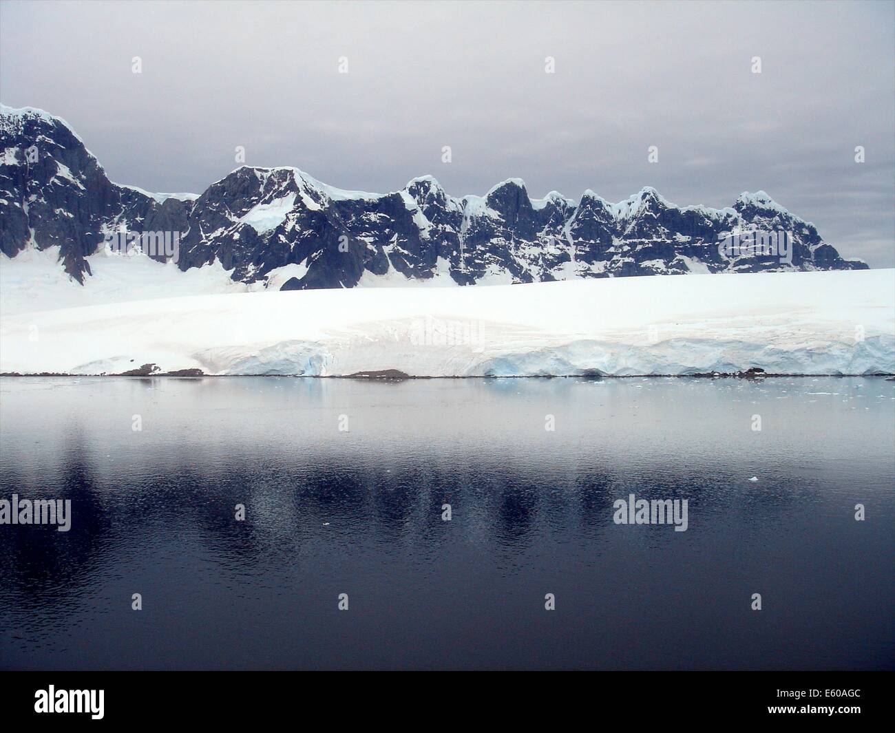 Snow, rock and ice reflections at sunset on the Antarctic Peninsula Stock Photo