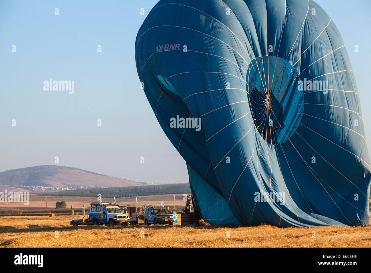 Hot air balloon being deflated. Photographed in the Jezreel Valley, Israel Mount Gilboa in the background Stock Photo