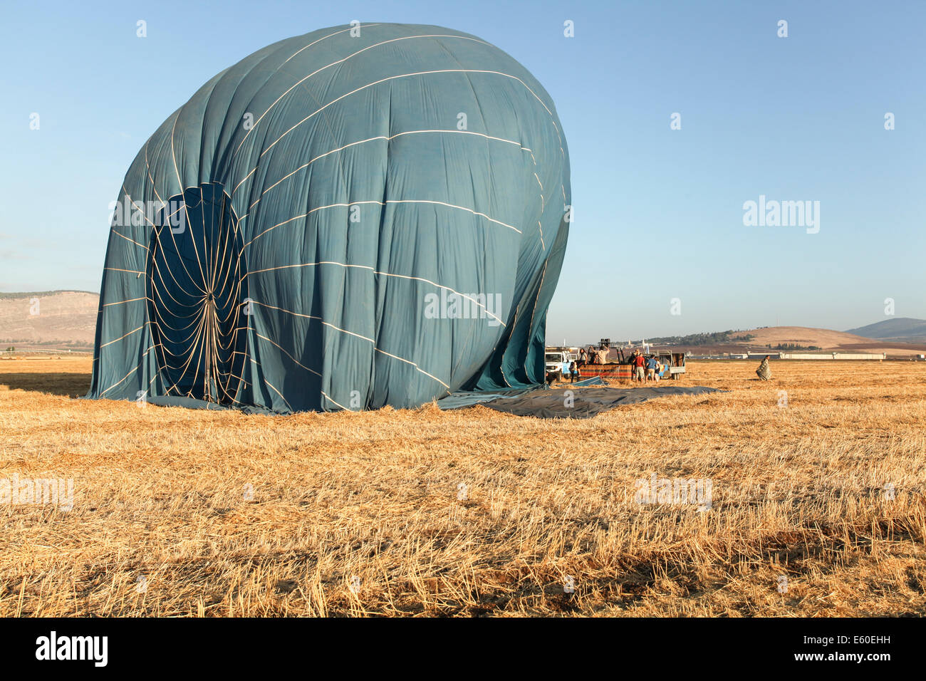 Hot air balloon being deflated. Photographed in the Jezreel Valley, Israel Mount Gilboa in the background Stock Photo