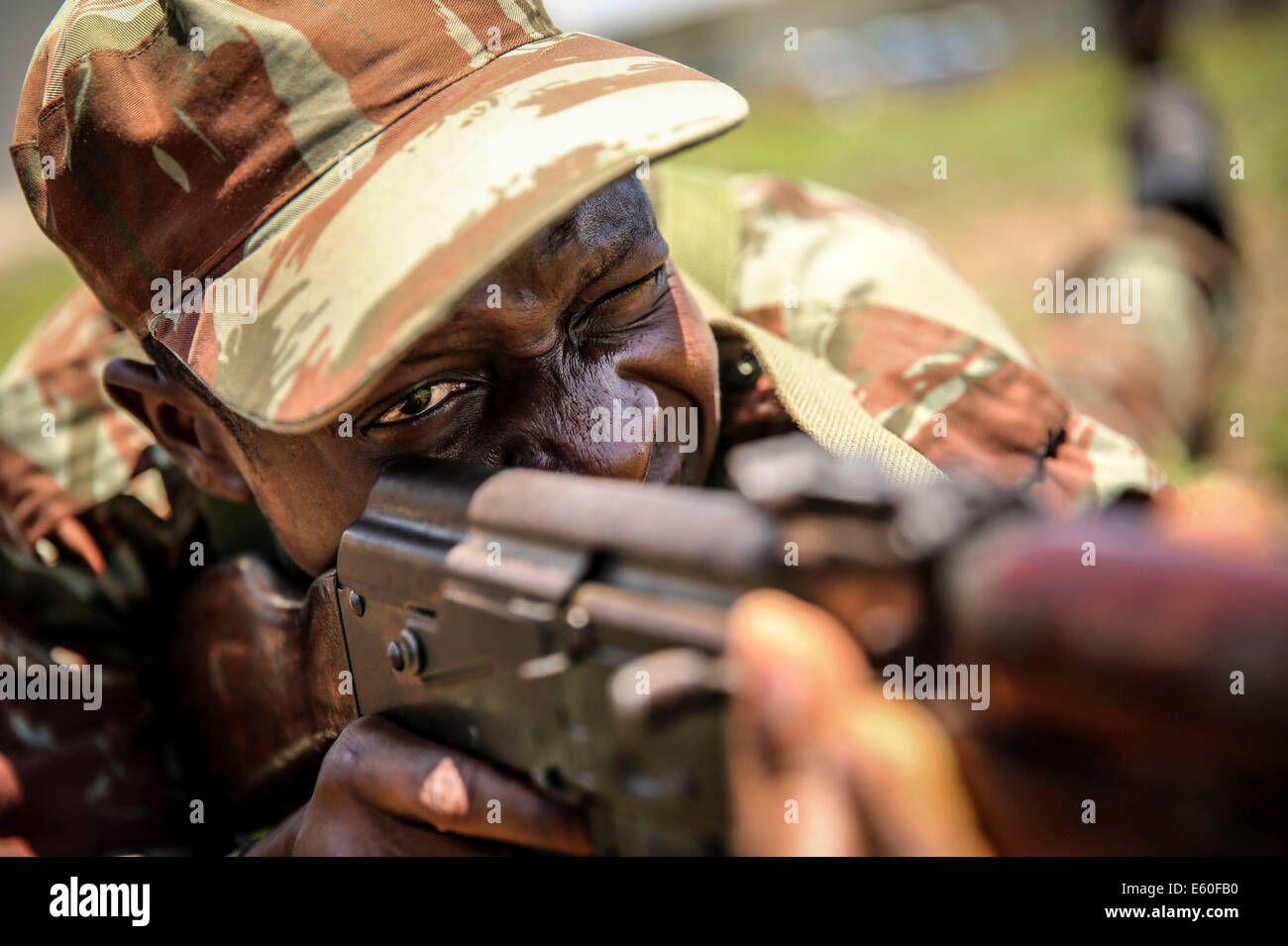 A Benin soldier looks through the sites of his AK-47 rifle during a weapons handling class held by US Marines October 9, 2013 in Cotonou, Benin. Stock Photo