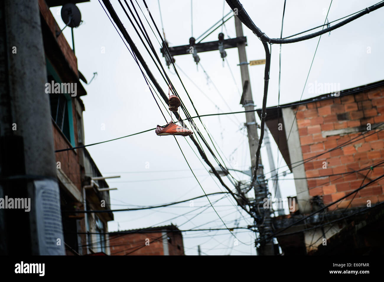 Rio De Janeiro, RJ, Brazil. 8th Aug, 2014. Old shoes hanging from  electrical wires in Complexo do Alemao. Residents are protesting for peace  in the favela and against the shootings that have