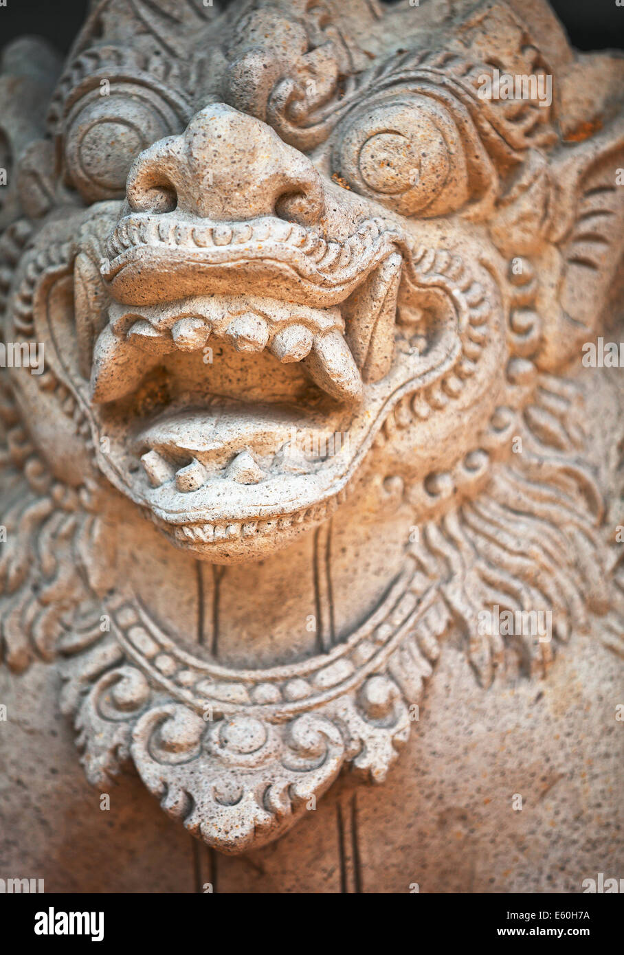 Muzzle of terrible mythical monster. Stone old statue from Indonesia, Bali island Stock Photo