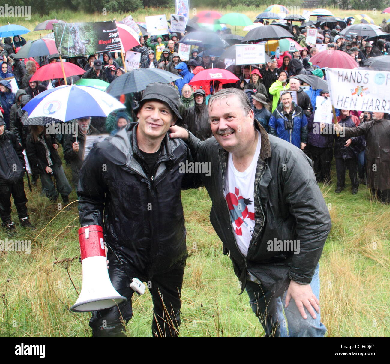 Peak District, Derbyshire, UK.  10th August, 2014. Two days before grouse shooting season opens, protesters led by BBC presenter, Chris Packham (L) and former RSPB Conservation Director, Mark Avery (R) gather by Derwent Dam, Upper Derwent Valley to express their opposition to the killing of hen harriers. According to the RSPB, Northern England’s uplands should have 320 pairs of breeding hen harriers but no chicks were raised in England in ‘13. Credit:  Deborah Vernon/Alamy Live News Stock Photo