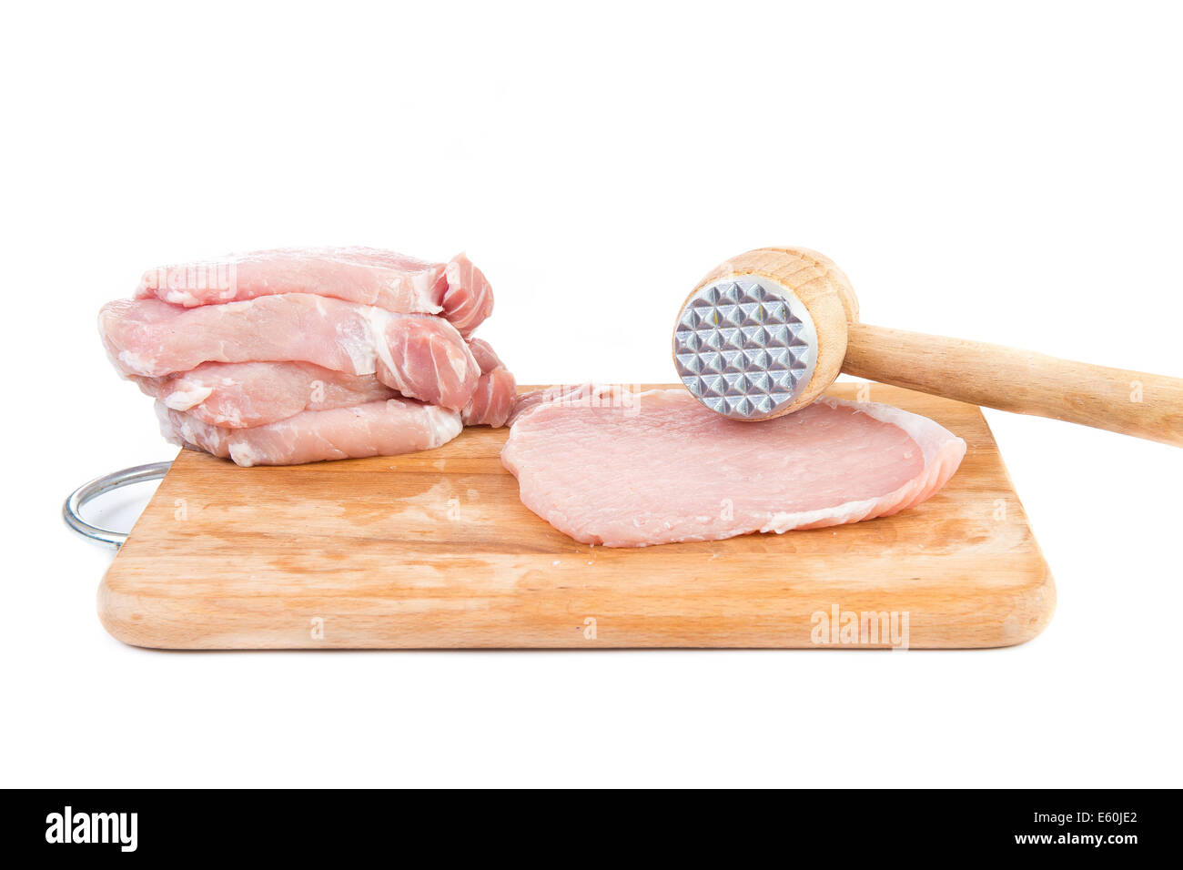 raw meat and meat tenderizer on board - white background Stock Photo