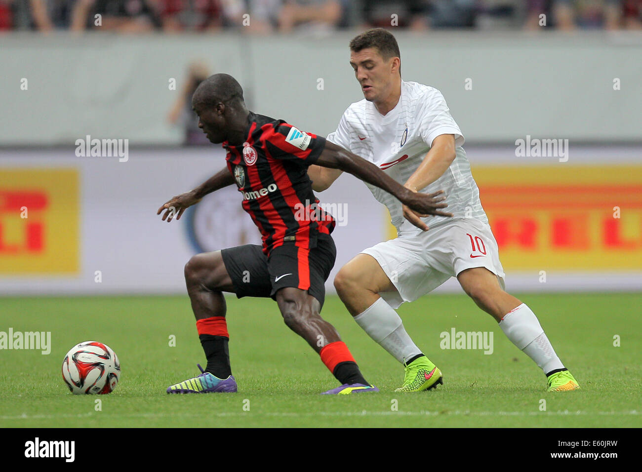 Frankfurt's Constant Djakpa (L) and Milan's Mateo Kovacic (R) vie for the ball during the soccer test match between Eintracht Frankfurt and Inter Milan at Commerzbank arena in Frankfurt/Main, Germany, 10 August 2014. Photo: Fredrik von Erichsen/dpa Stock Photo