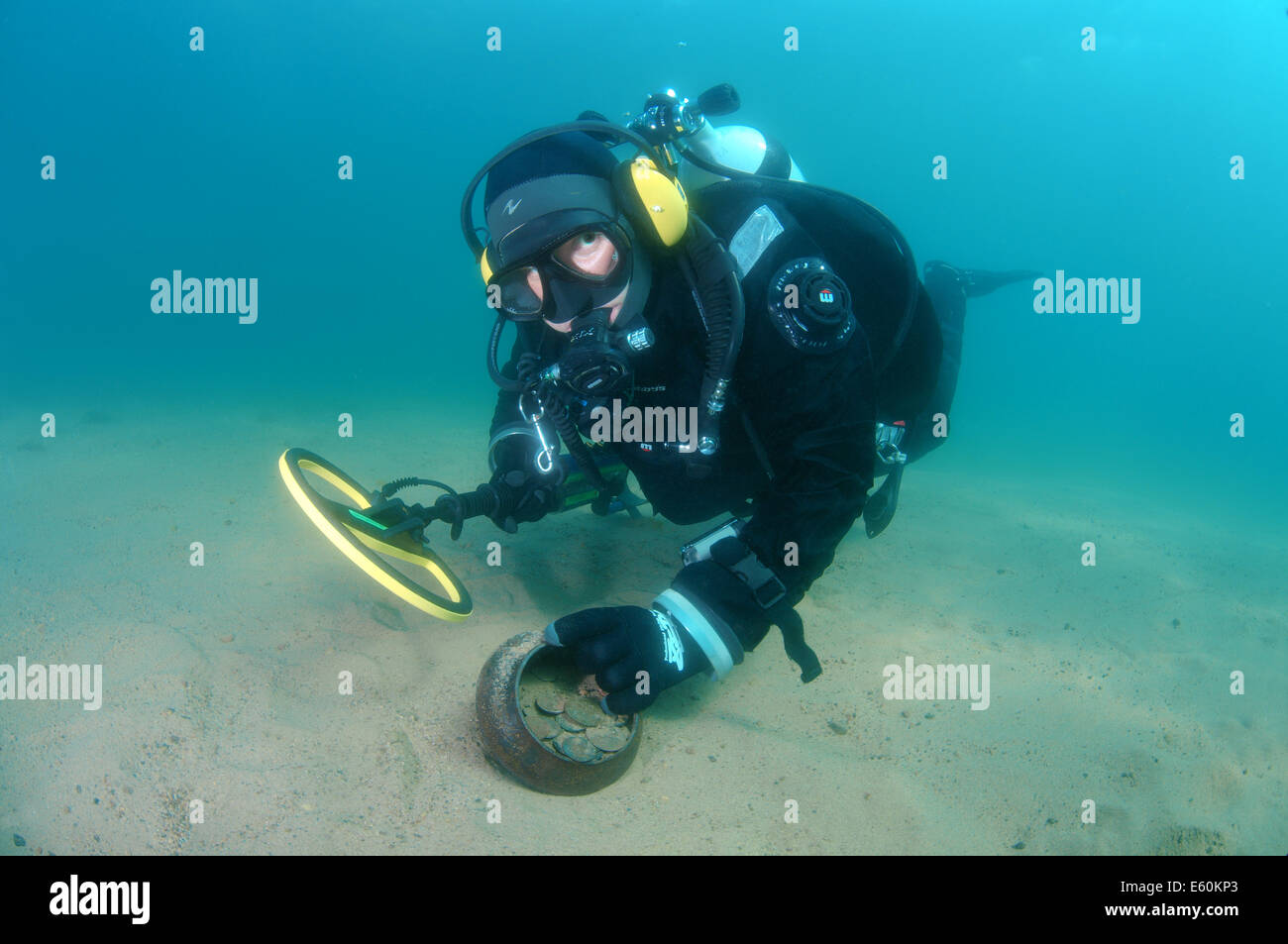 Diver with the metal detector found a pot with antique coins, lake Baikal, Siberia, Russia, Eurasia Stock Photo