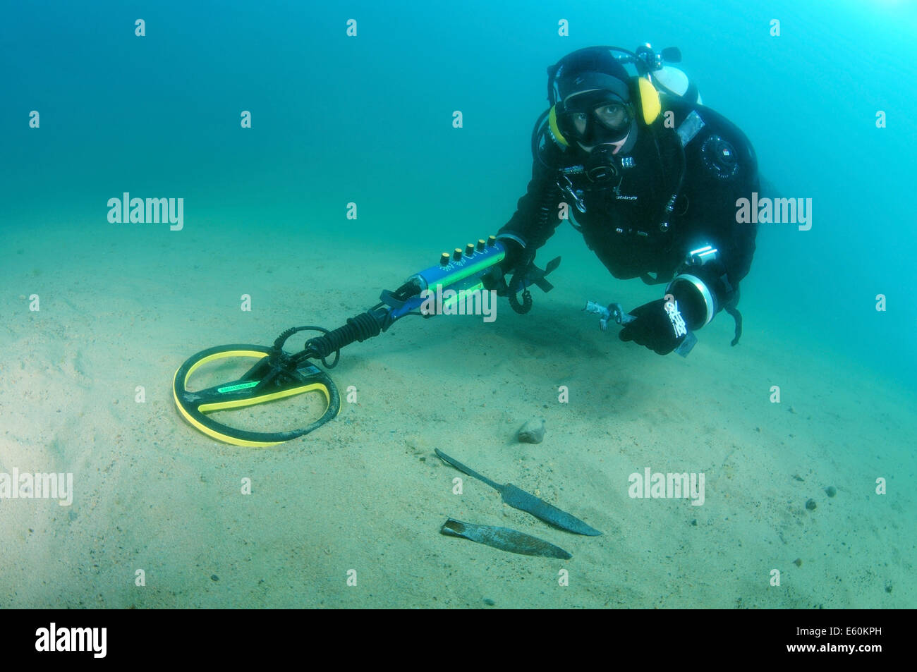 Diver with the metal detector shows found an ancient spearhead.  lake Baikal, Siberia, Russia, Eurasia Stock Photo