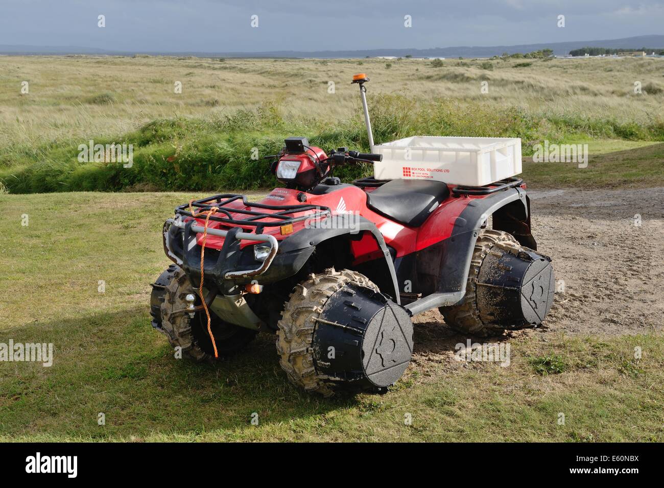 Quad bike with wheel extensions to prevent sinking in soft ground Stock Photo