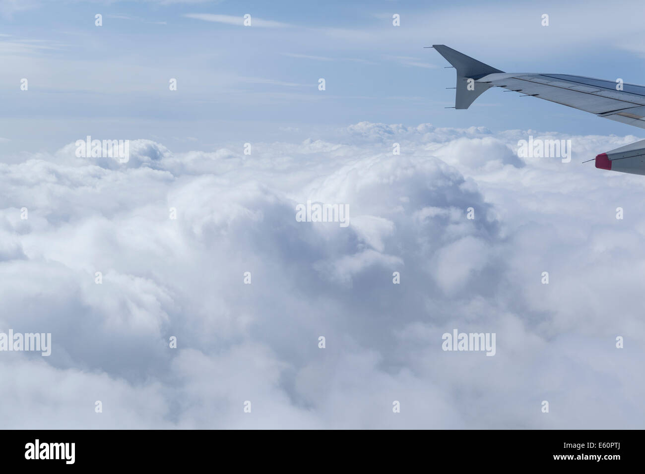 Plane wing above cloud formation Stock Photo