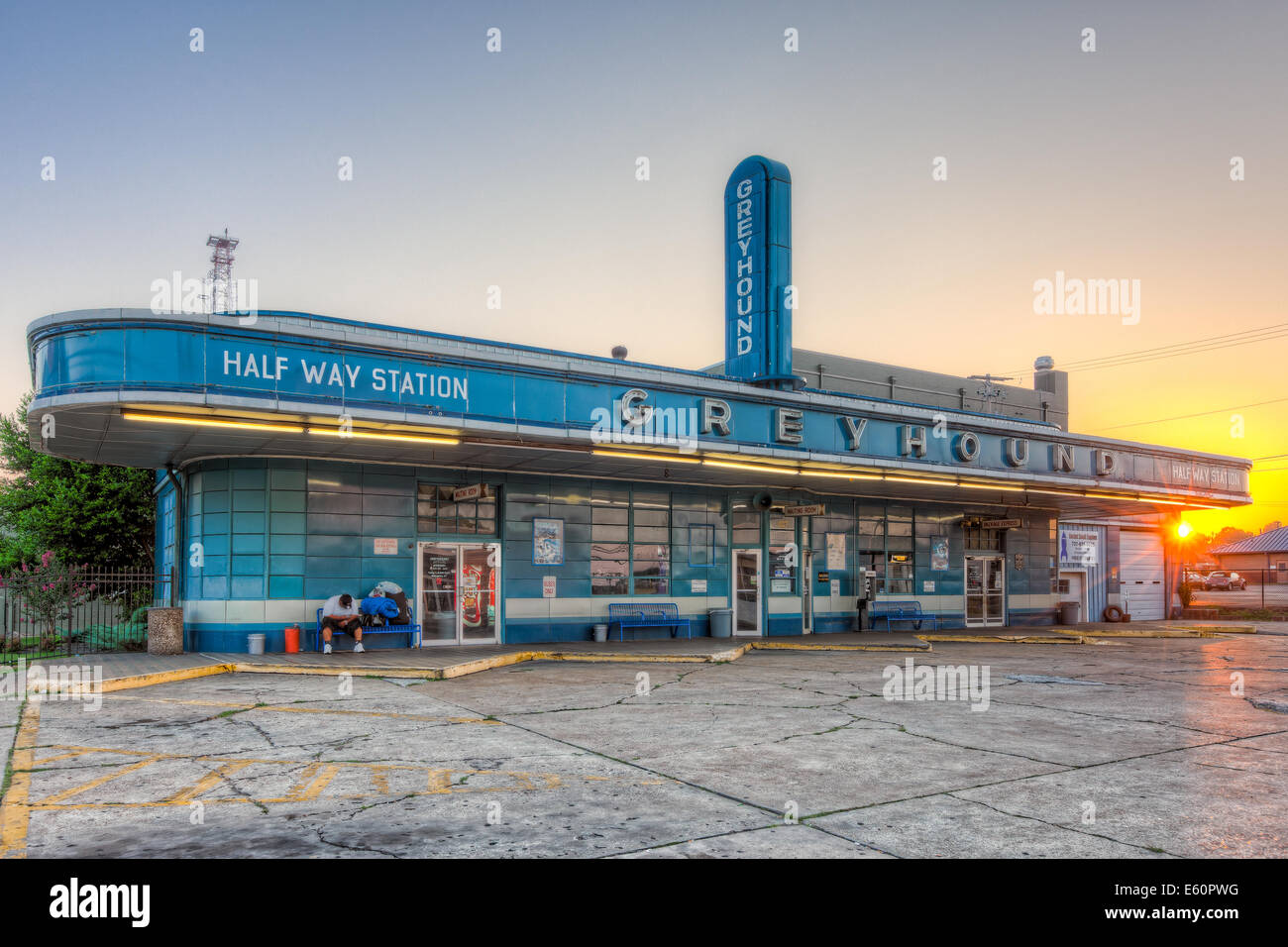 A lone passenger waits for the first bus at sunrise at the historic Greyhound Bus Station in Jackson, Tennessee. Stock Photo