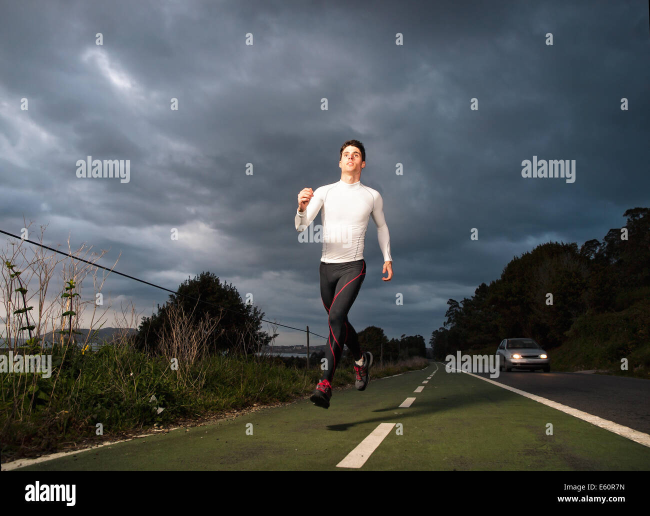 Runner man in the road at night outdoors Stock Photo
