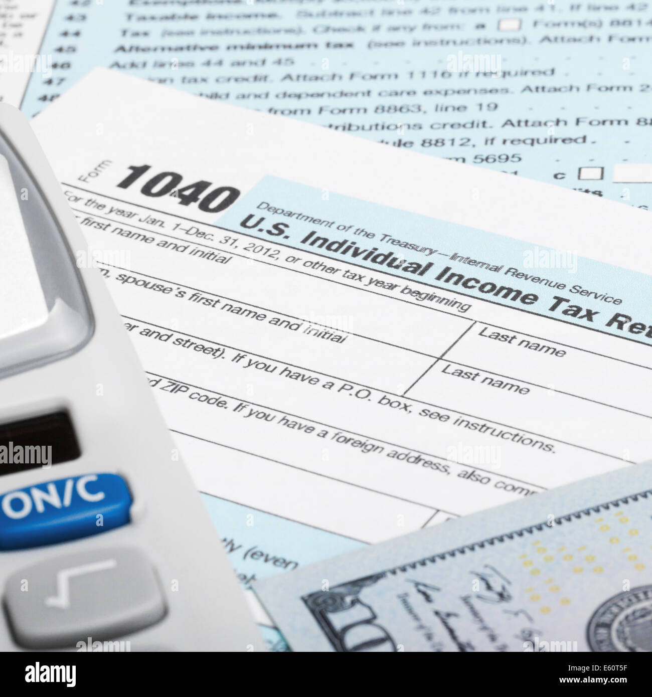 Tax Form 1040 with calculator and 100 US dollar bills Stock Photo Alamy