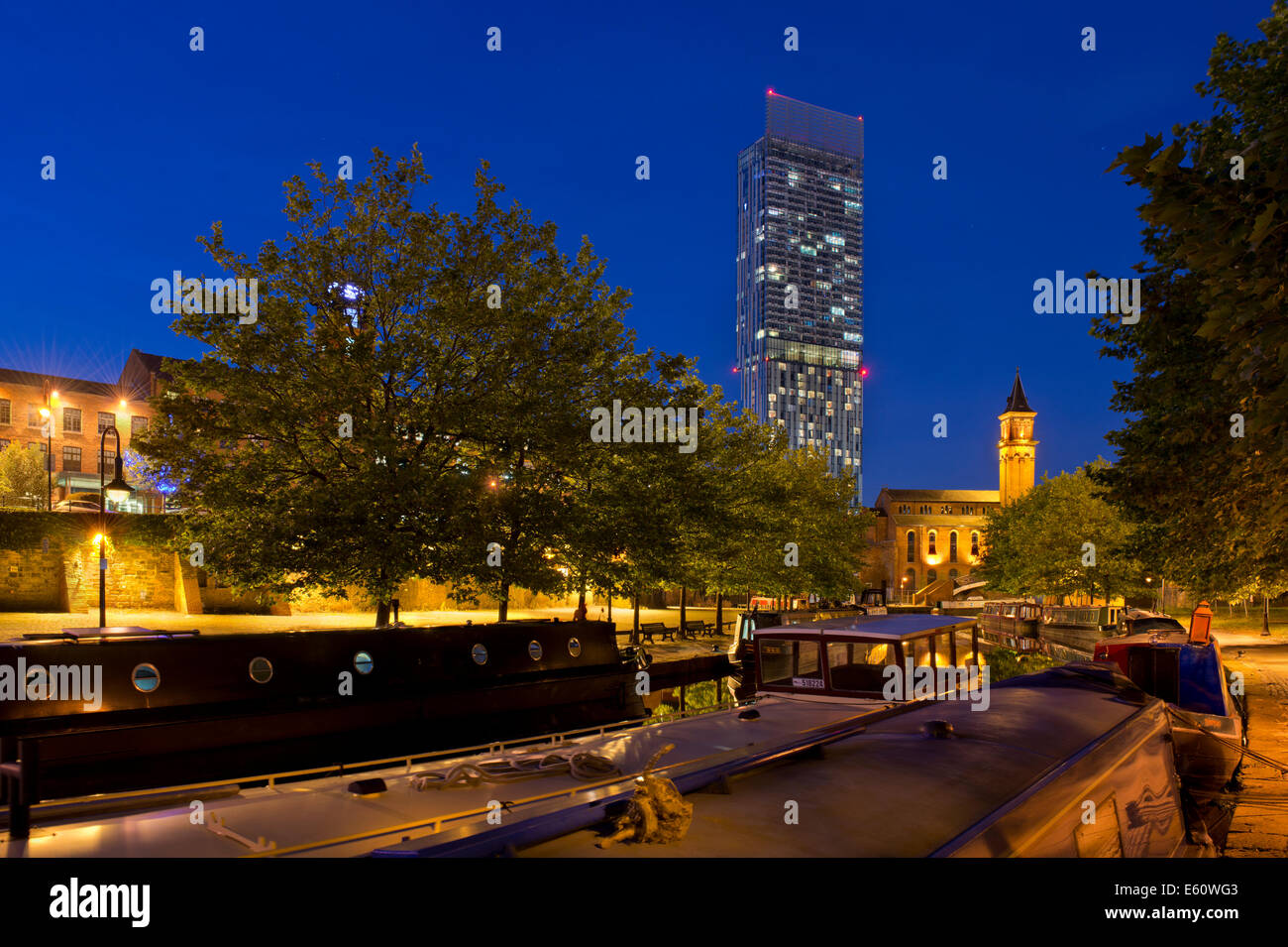 The Castlefield Urban Heritage Park and historic inner city canal conservation area with Beetham Tower in Manchester at night. Stock Photo