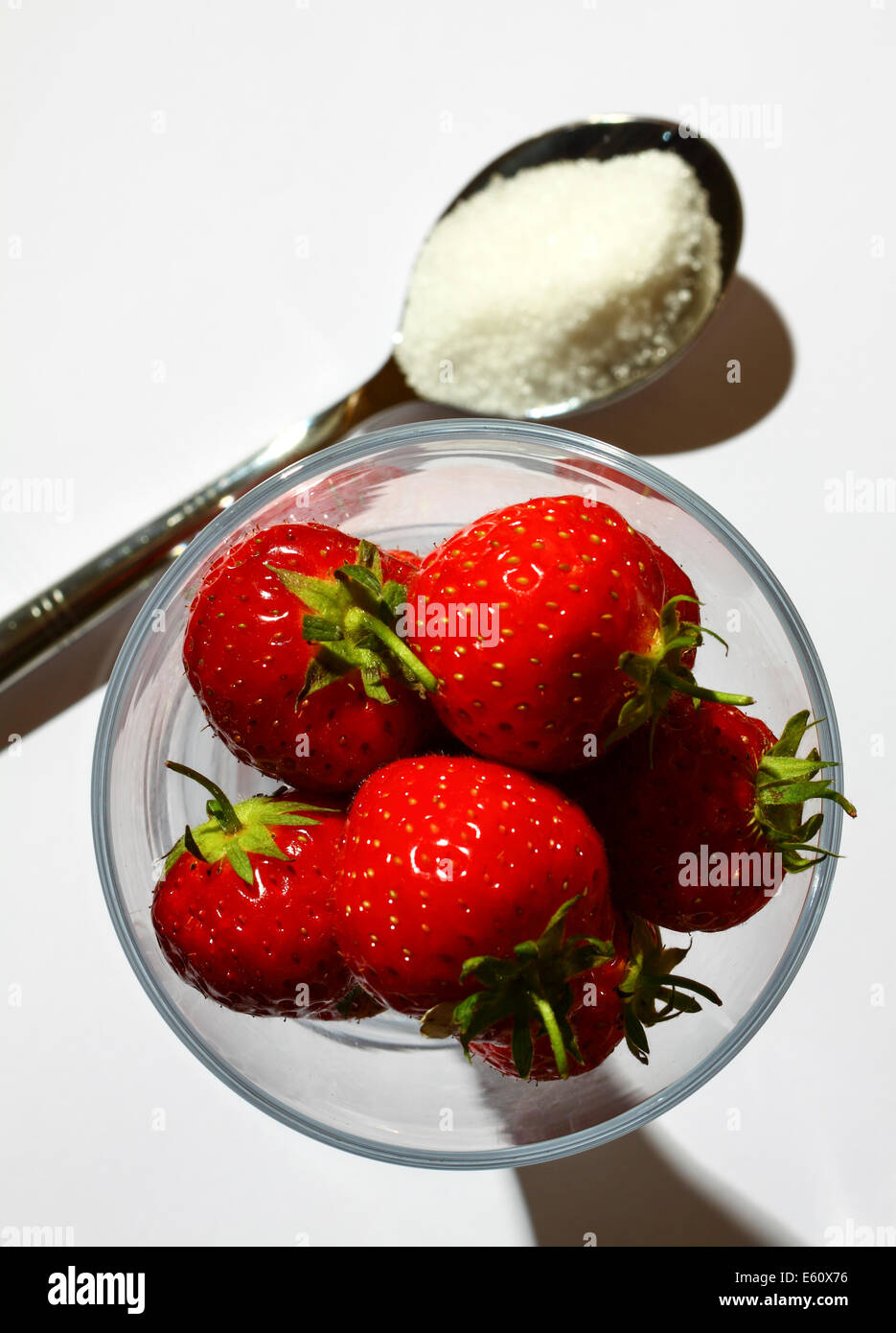 Strawberries in a glass and a spoonful of sugar Stock Photo - Alamy