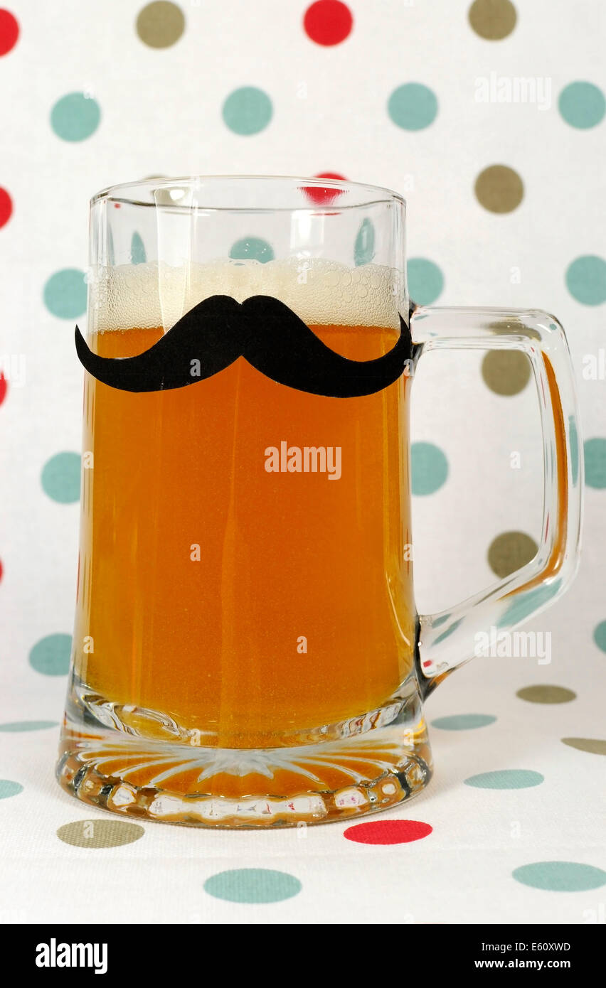 Social Mustache on beer stein against a polka dot background,  for Movember to raise awareness for male health problems. Stock Photo