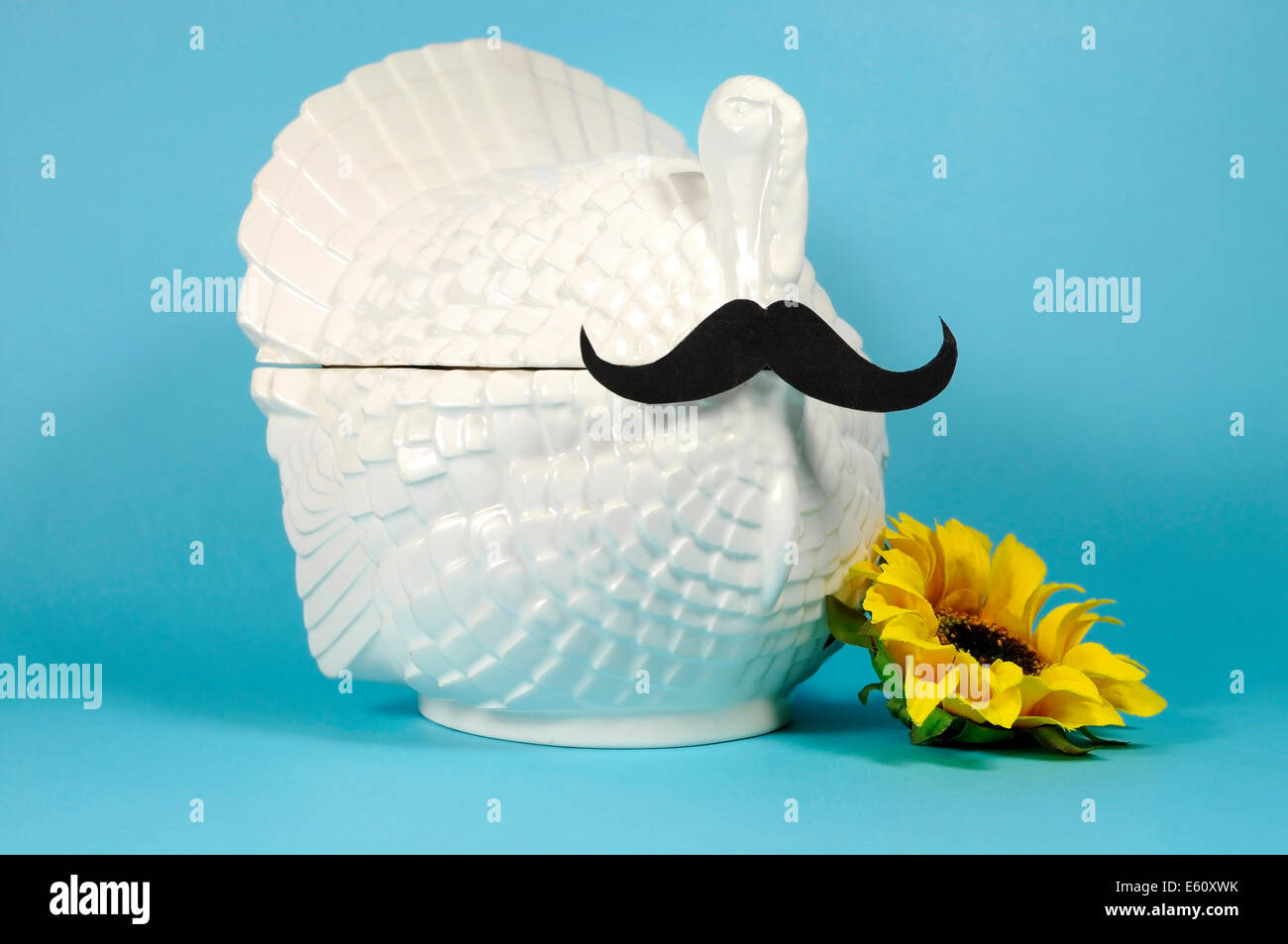 Thanksgiving Mustache on a vintage turkey tureen with sunflower for Movember to raise awareness for male health problems. Stock Photo