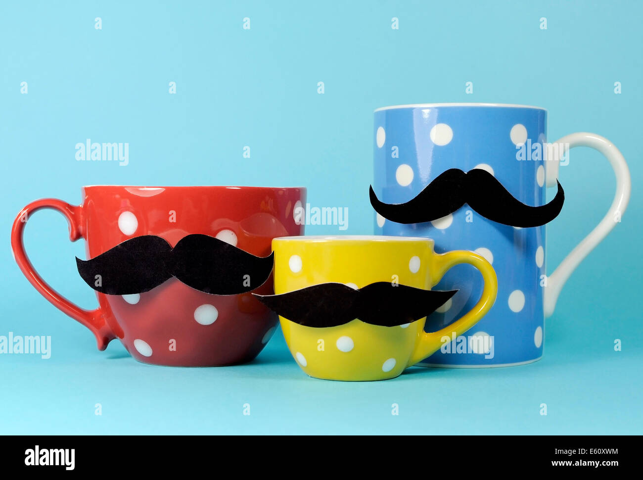 A family of mustaches on blue, red and yellow polka dot coffee and tea cups and mugs,  for Movember to raise awareness for male Stock Photo