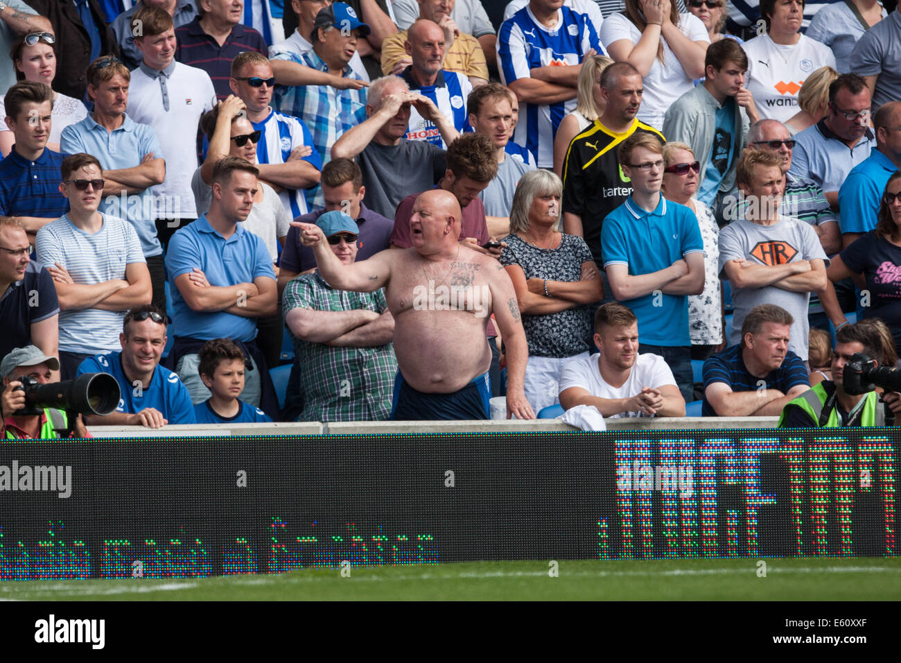 Overweight man in a football crowd Stock Photo