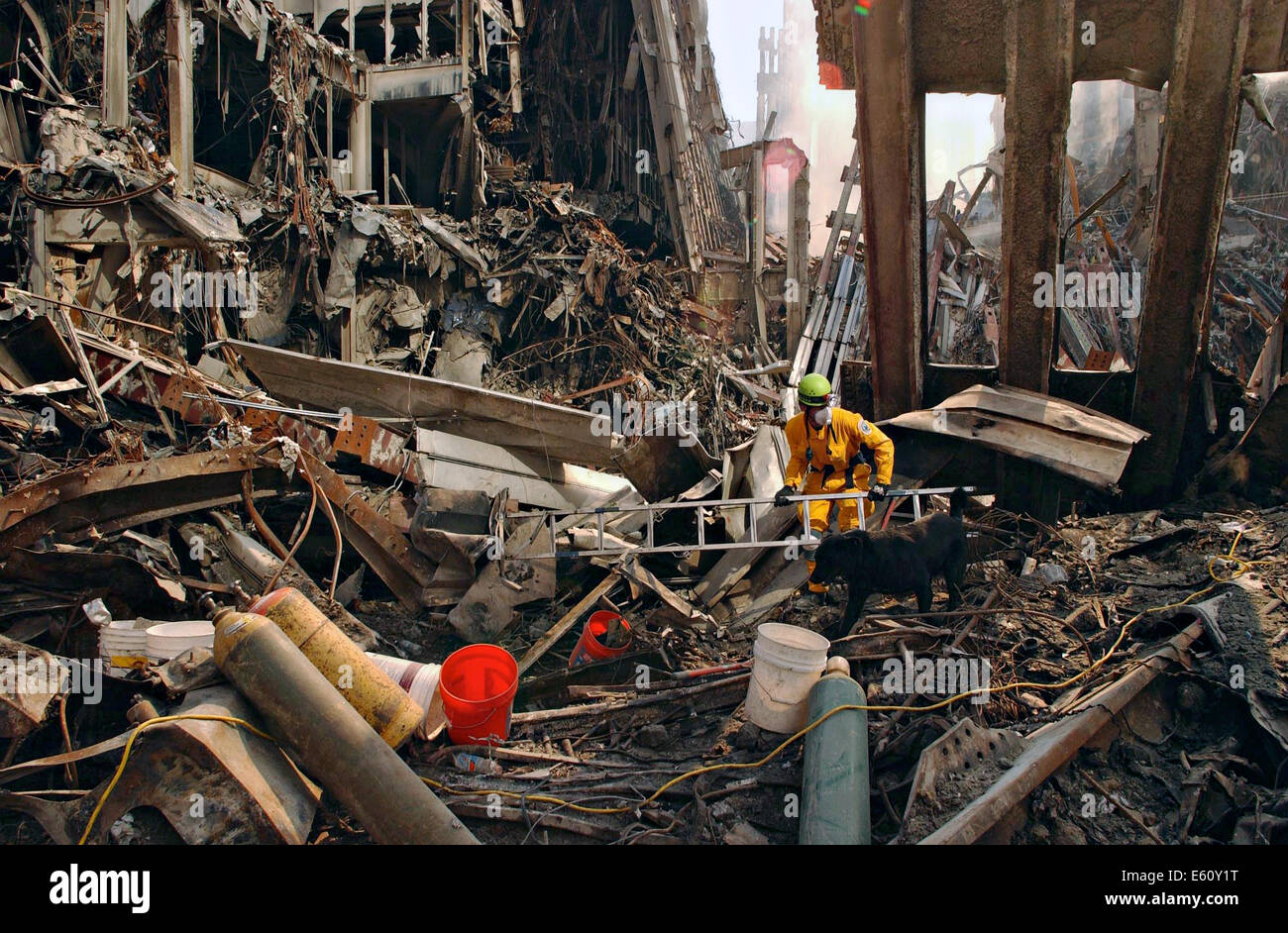 Rescue workers pick through debris and work with rescue dogs as they continue the recovery of victims amongst the wreckage of the World Trade Center in the aftermath of a massive terrorist attack which destroyed the twin towers killing 2,606 people September 17, 2001 in New York, NY. Stock Photo