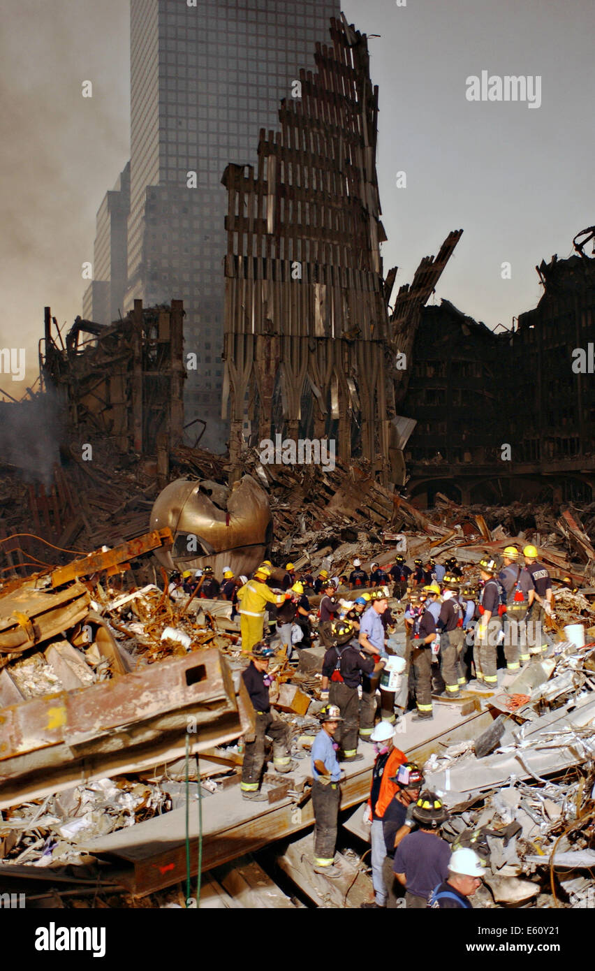 Rescue workers continue to remove debris by the facade of the wreckage of the World Trade Center in the aftermath of a massive terrorist attack which destroyed the twin towers killing 2,606 people September 17, 2001 in New York, NY. Stock Photo