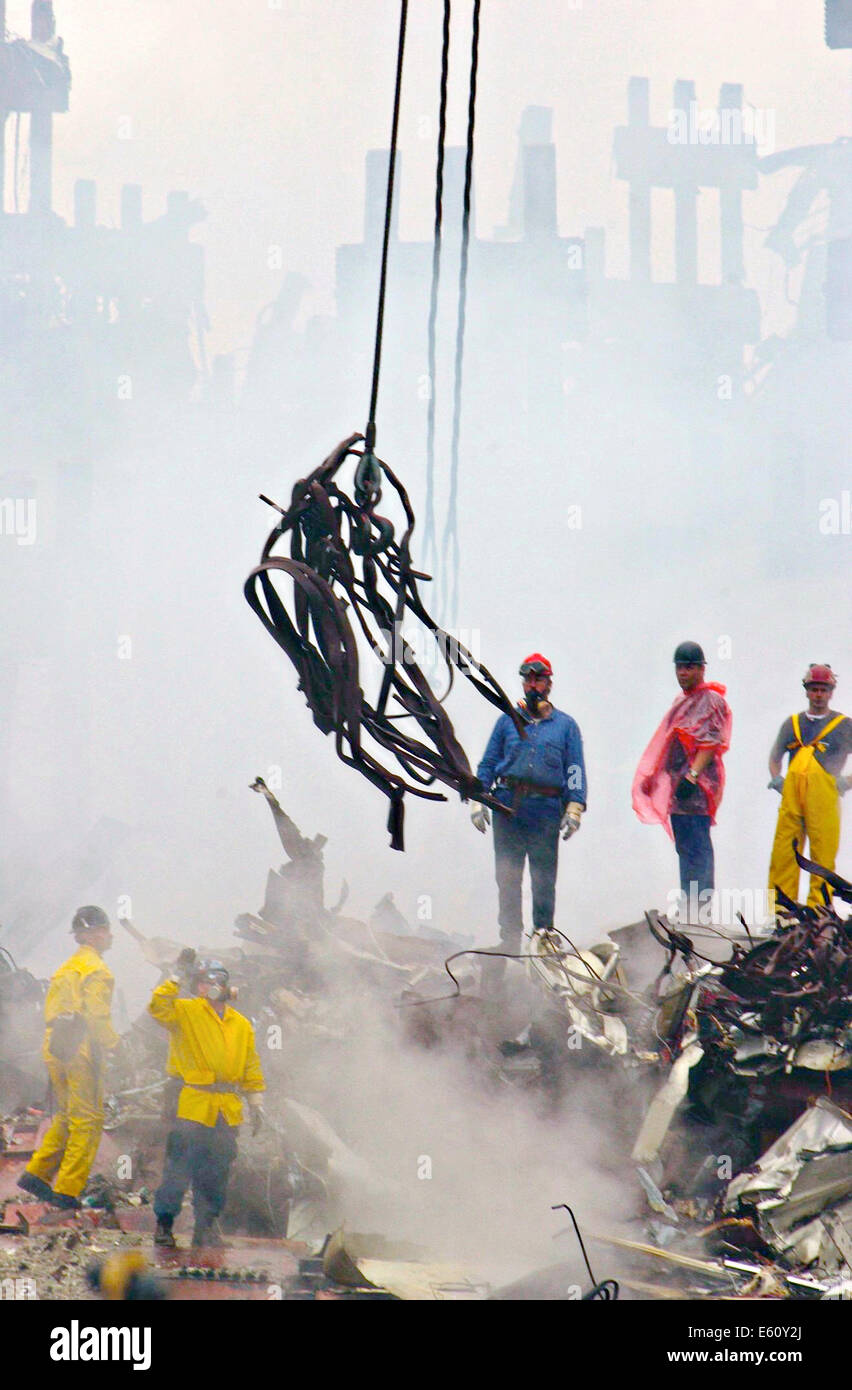 Rescue workers use cranes to clear twisted metal from the pile of rubble amongst the wreckage of the World Trade Center in the aftermath of a massive terrorist attack which destroyed the twin towers killing 2,606 people September 20, 2001 in New York, NY. Stock Photo