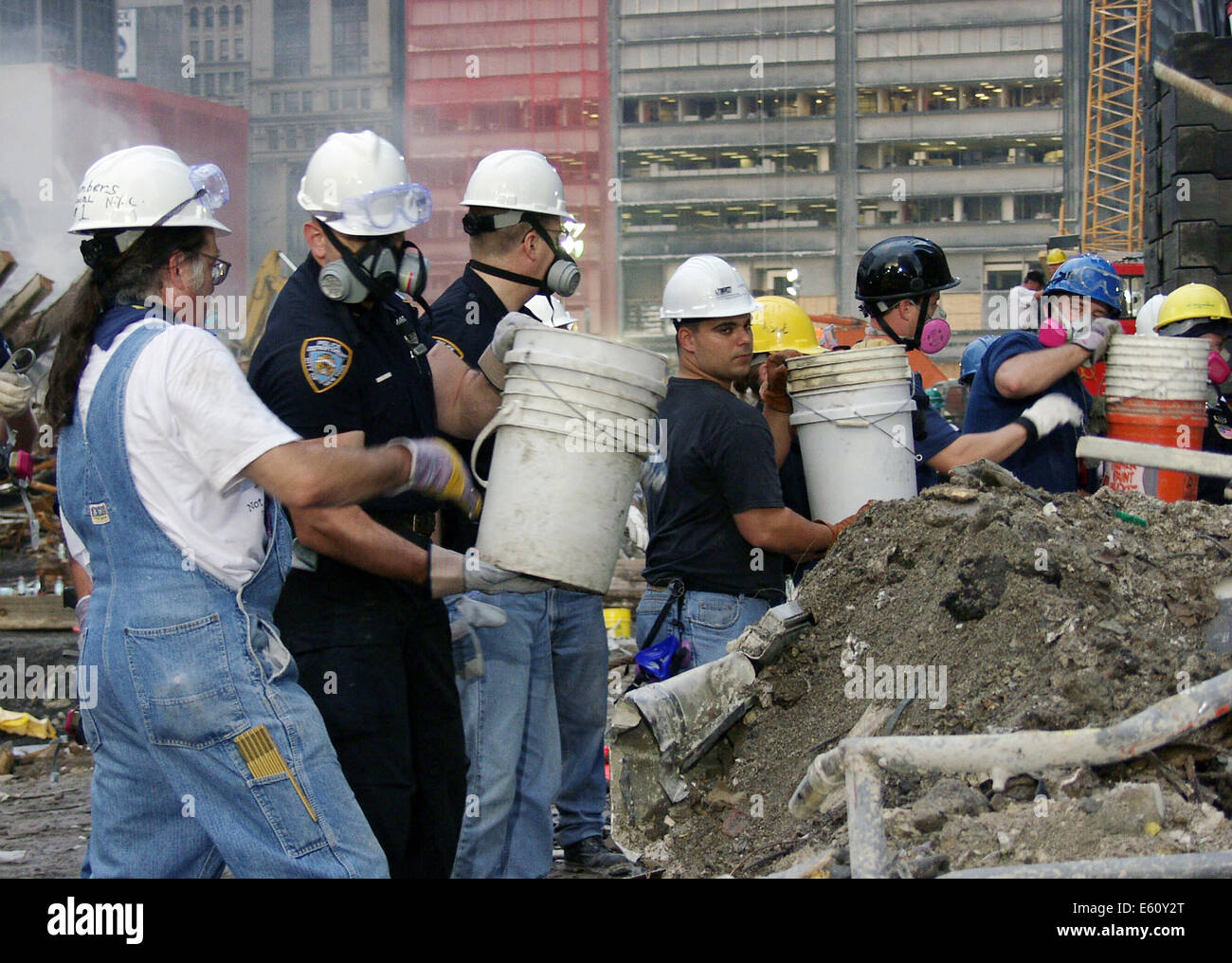 Rescue workers man a bucket brigade to remove debris from the wreckage of the World Trade Center in the aftermath of a massive terrorist attack which destroyed the twin towers killing 2,606 people September 20, 2001 in New York, NY. Stock Photo