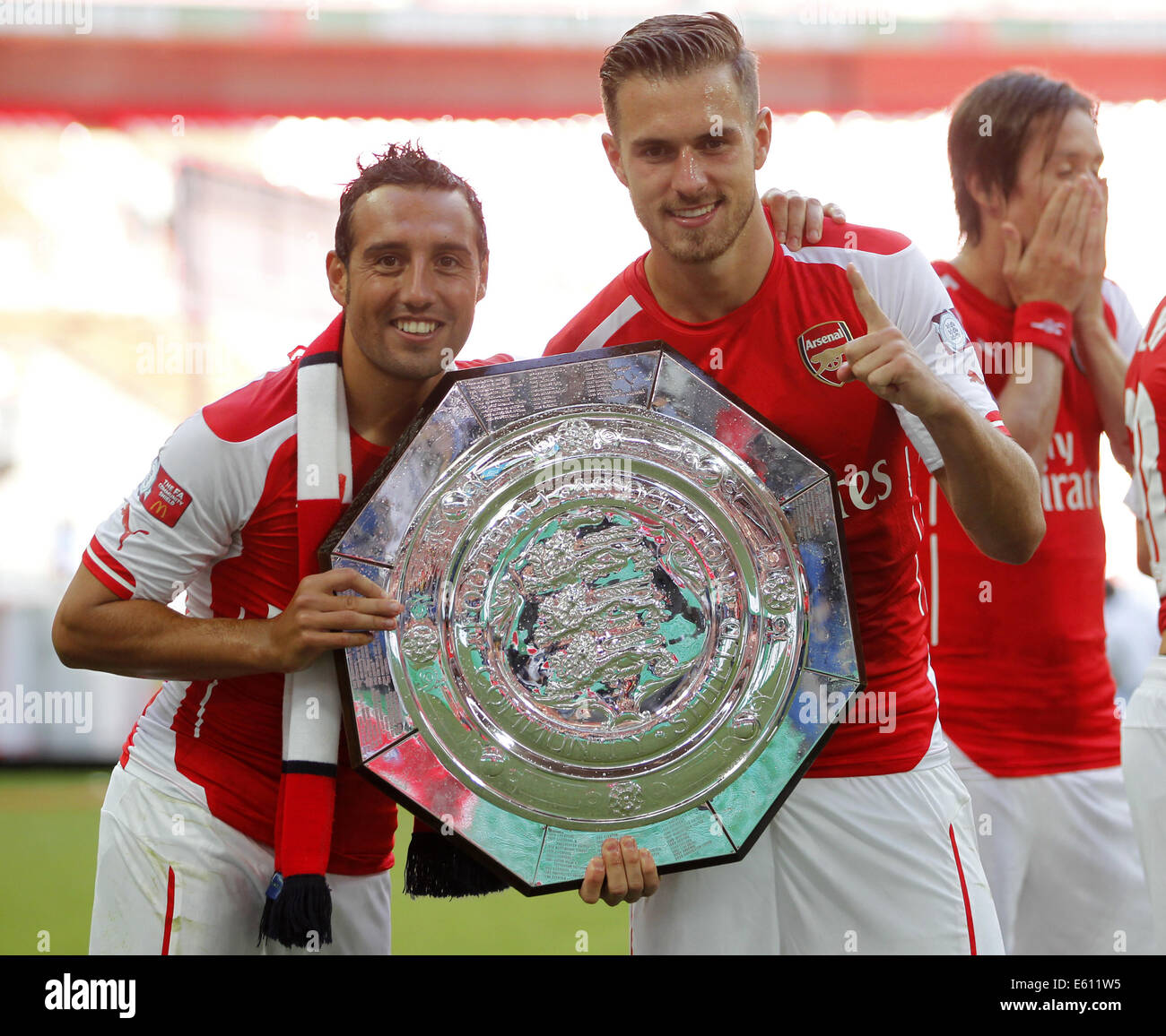 London, UK. 10th Aug, 2014. Santi Cazorla(L) and Aaron Ramsey of Arsenal pose with the community shield after the Community Shield match between Arsenal and Manchester City at Wembley Stadium in London, Britain on Aug. 10, 2014. Arsenal won 3-0. Credit:  Wang Lili/Xinhua/Alamy Live News Stock Photo