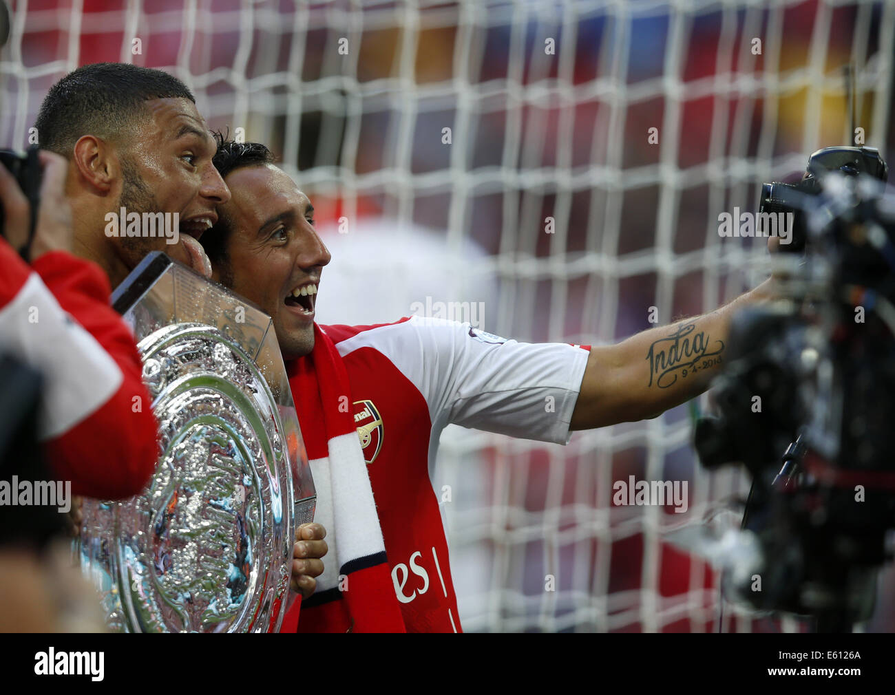 London, UK. 10th Aug, 2014. Santi Cazorla (R) and Alex Oxlade-Chamberlain of Arsenal take a photo with a remote camera after the Community Shield match between Arsenal and Manchester City at Wembley Stadium in London, Britain on Aug. 10, 2014. Arsenal won 3-0. Credit:  Wang Lili/Xinhua/Alamy Live News Stock Photo