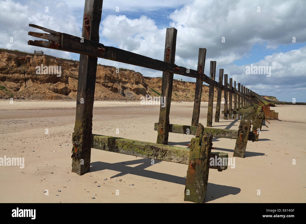 Broken sea defences with eroded cliffs at Happisburgh north Norfolk ...