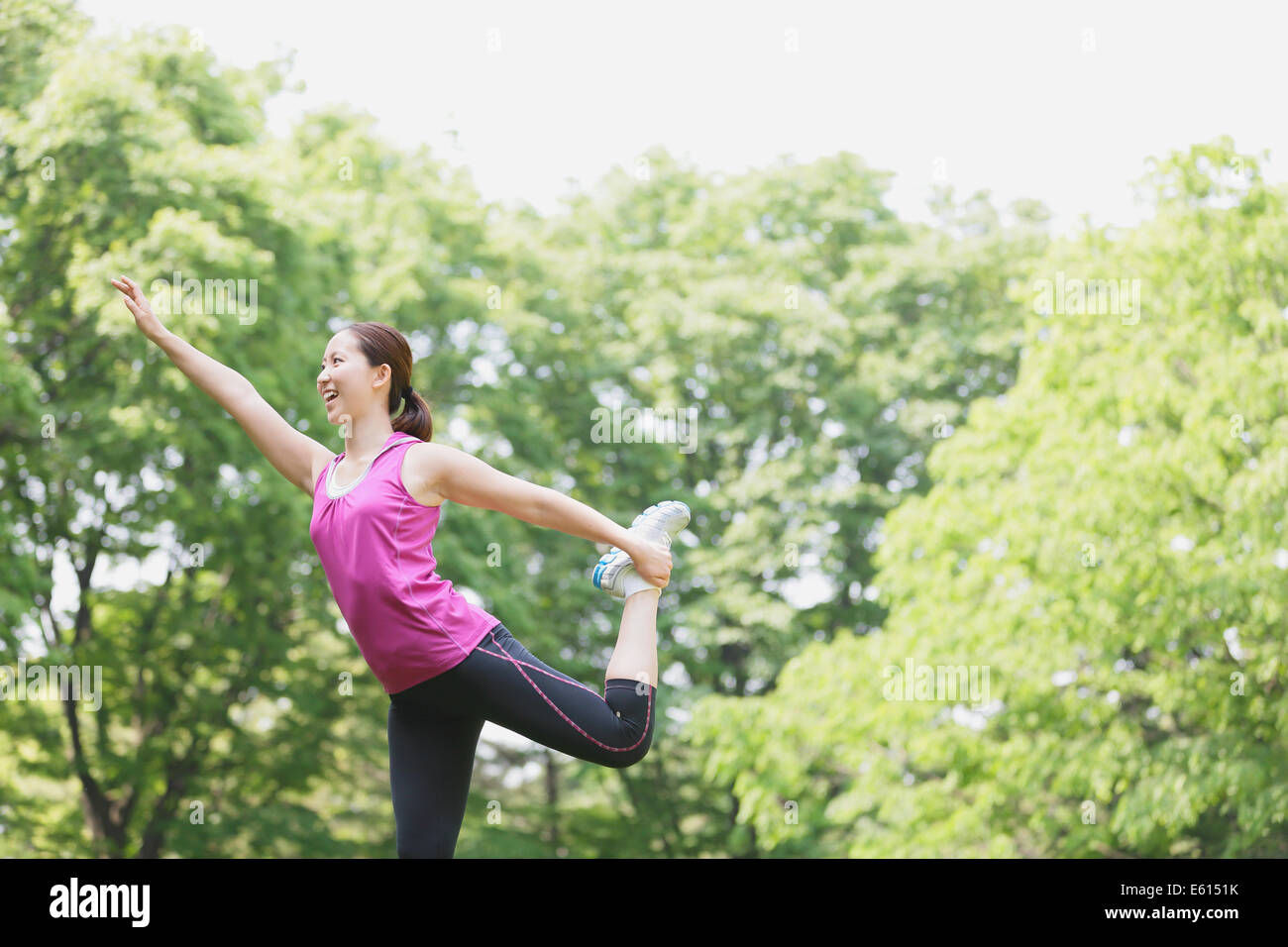 Young Japanese girl stretching in the park Stock Photo Alamy