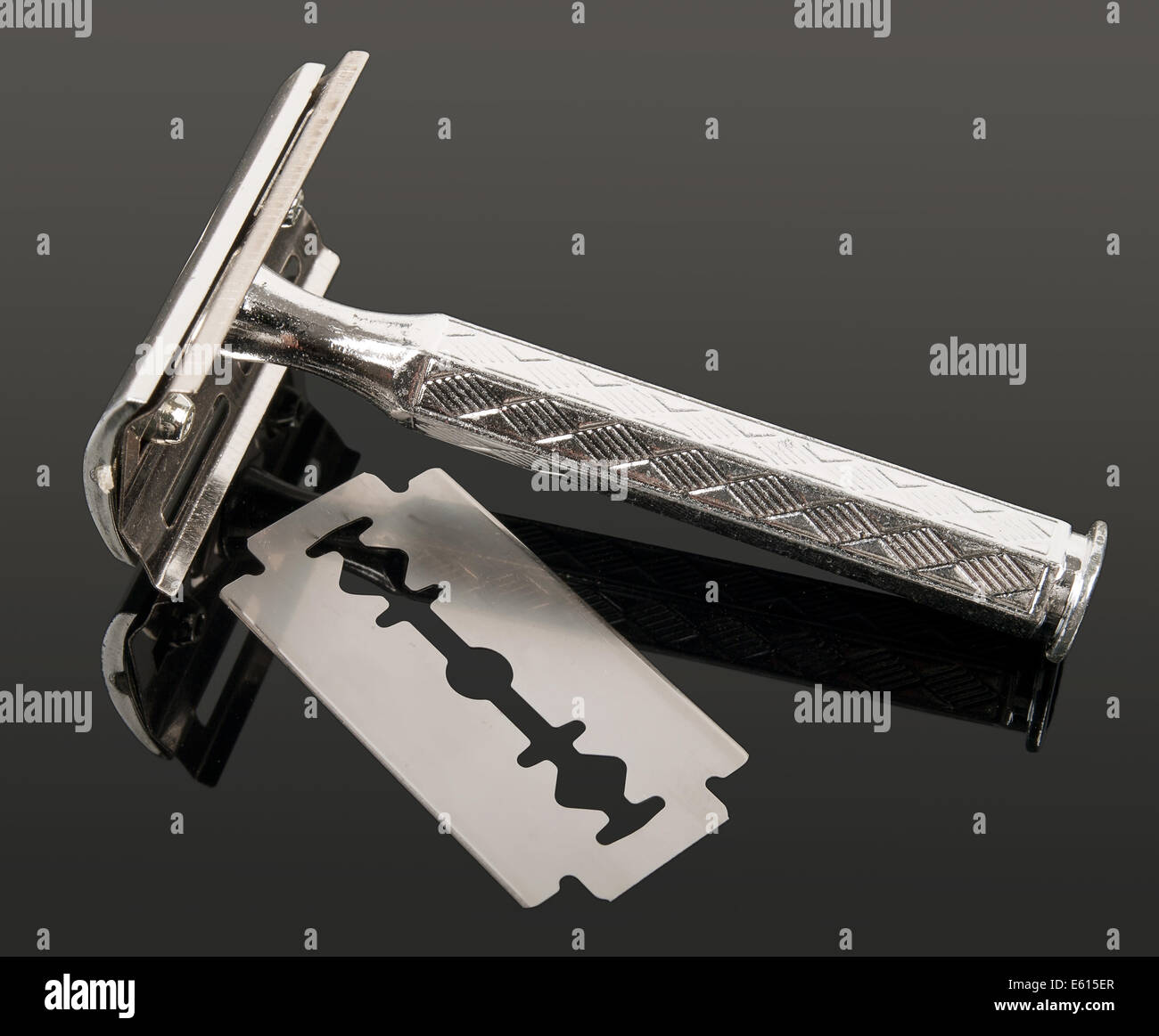 vintage razor and blade with reflection isolated on gray background Stock Photo