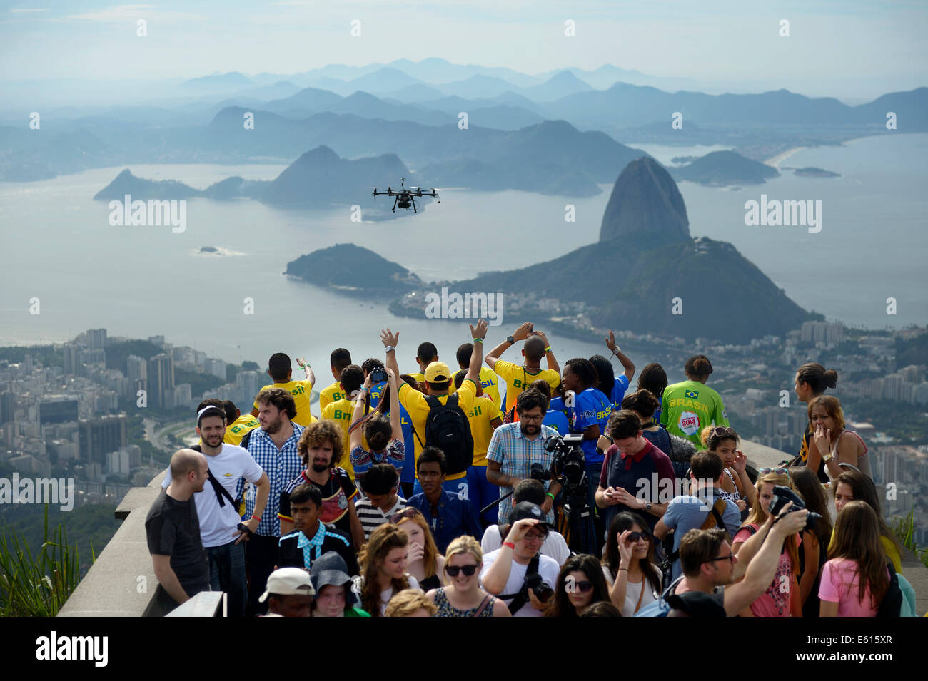 People cheering in the direction of a drone with cameras, Octopoter, on the observation deck in front of the Christ the Redeemer Stock Photo